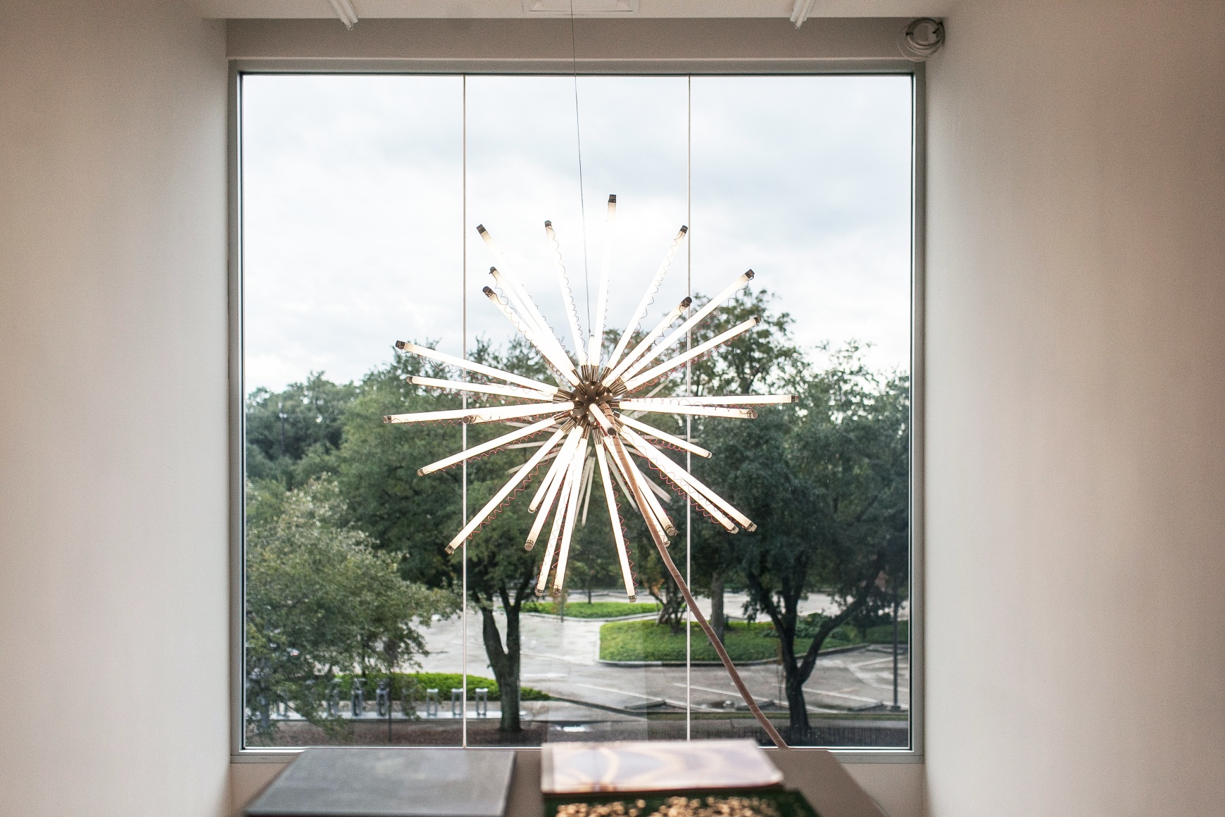 Thomas Glassford, Aster 140 T8/4100 K (red), 2003. Fluorescent light, nickel plated brass, orange wire, red wire, electrical hardware, 55in.