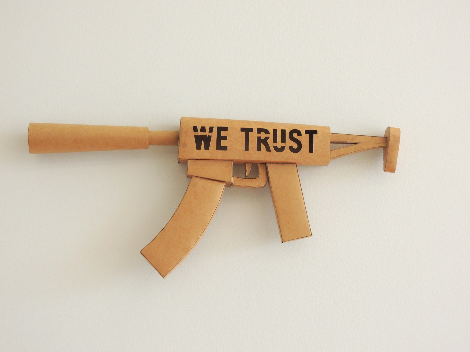 Miguel Angel R&iacute;os, WE TRUST, 2011. Mexican craft paper, 11 x 80 5/16 x 1 1/16 in. (27.9 x 204 x 2.7 cm.)
