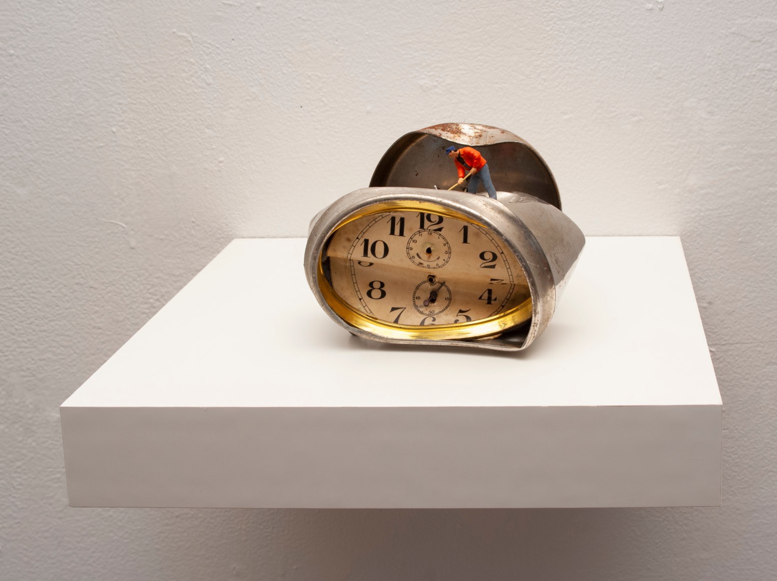 Liliana Porter, To Fix it [silver clock], 2019. Figurine and broken clock on white shelf, 4 1/2 x 6 x 4 in., (11.4 x 15.2 x 10.2 cm.)