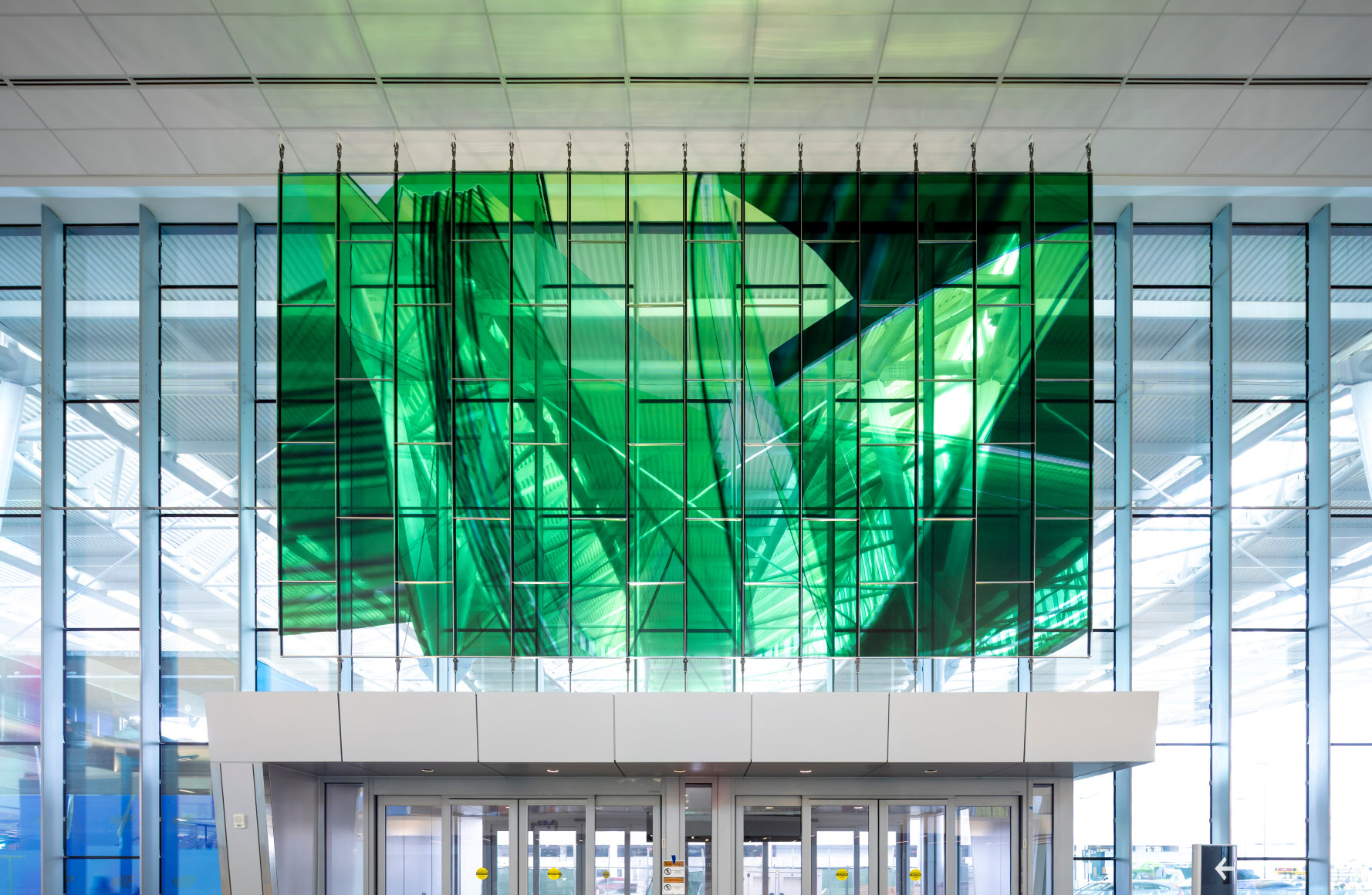 Marta Chilindron, Unexpected Spaces, 2025. Digital print on glass and polished stainless steel, 21&rsquo; x 20&rsquo; (yellow), 21&rsquo; x 35&rsquo; (green), 15&rsquo; x 27&rsquo; 6&rdquo; (blue). Permanent installation at George Bush Intercontinental Airport (IAH), Terminal E. Image courtesy of Houston Airports. Photos by Slyworks.
