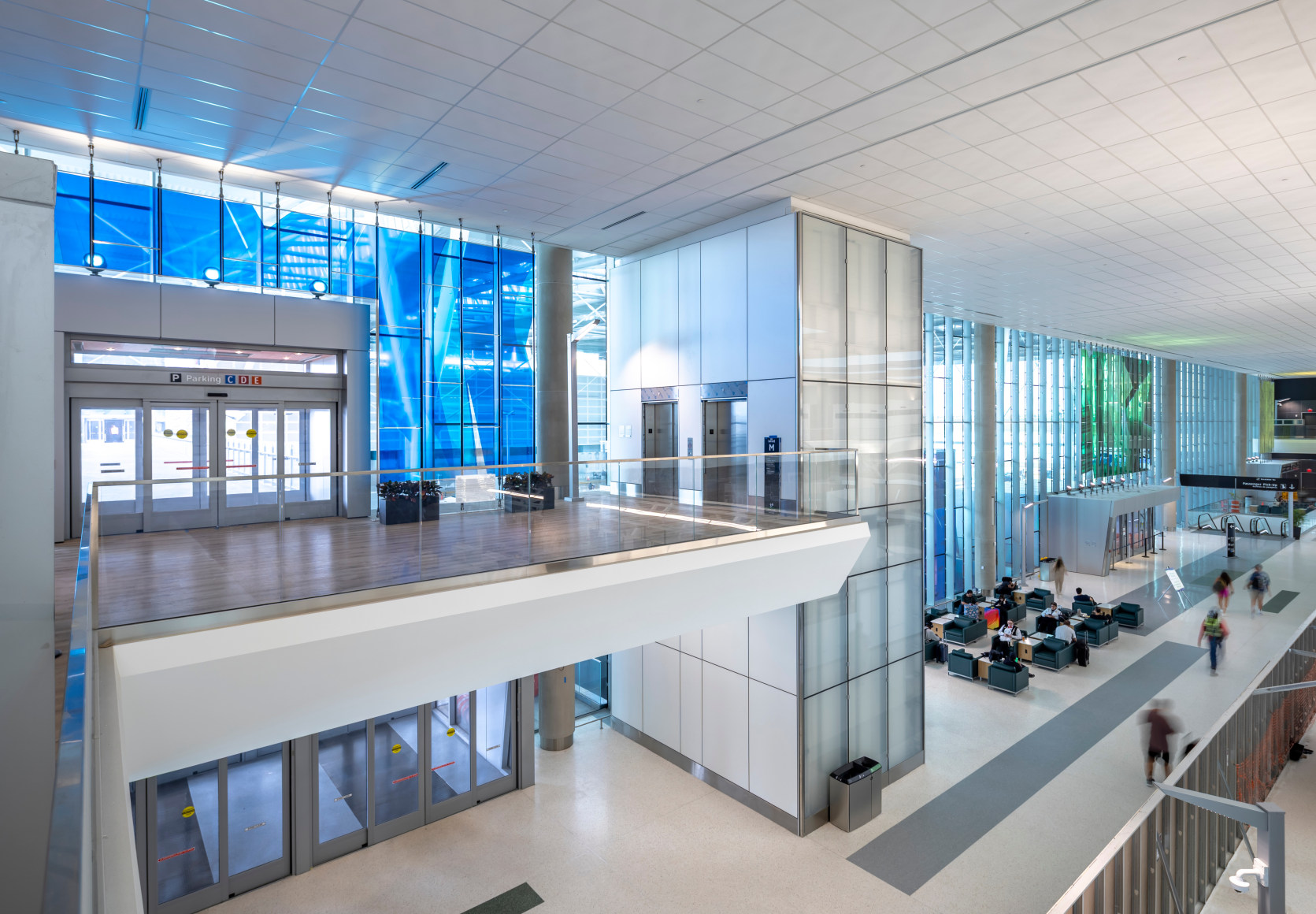 Marta Chilindron, Unexpected Spaces, 2025. Digital print on glass and polished stainless steel, 21&rsquo; x 20&rsquo; (yellow), 21&rsquo; x 35&rsquo; (green), 15&rsquo; x 27&rsquo; 6&rdquo; (blue). Permanent installation at George Bush Intercontinental Airport (IAH), Terminal E. Image courtesy of Houston Airports. Photos by Slyworks.