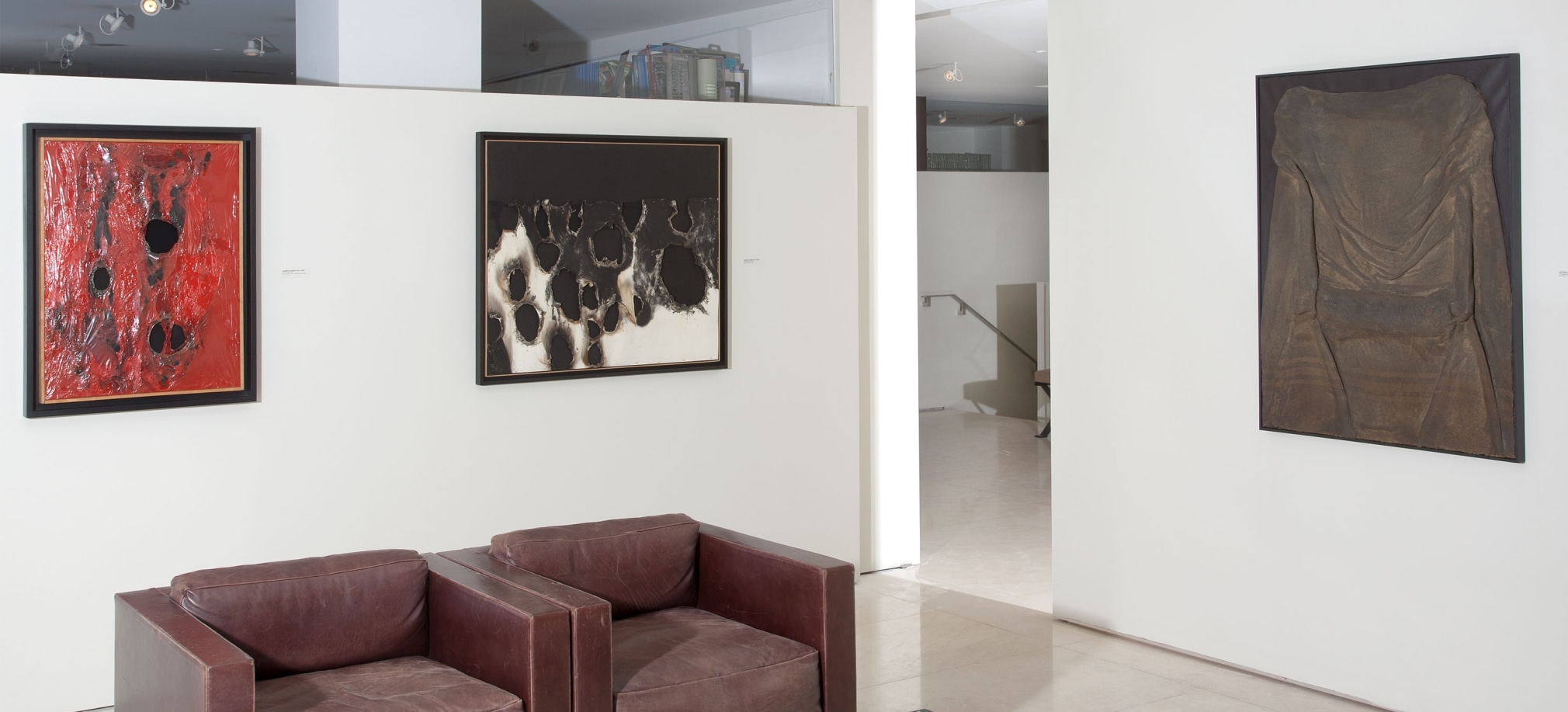 Installation view of The Wounded Canvas: Burri Fontana Manzoni T&agrave;pies. Photography by Guenter Knop. &copy;Helly Nahmad Gallery NY.