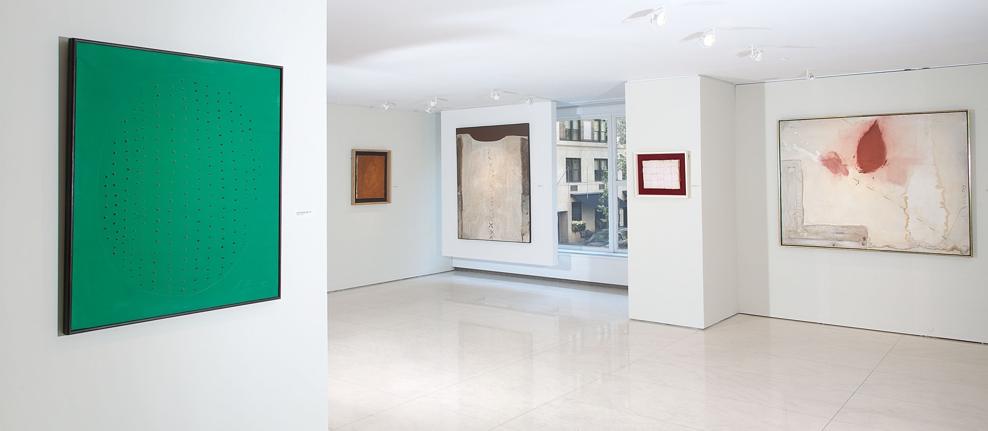 Installation view of The Wounded Canvas: Burri Fontana Manzoni T&agrave;pies. Photography by Guenter Knop. &copy;Helly Nahmad Gallery NY.