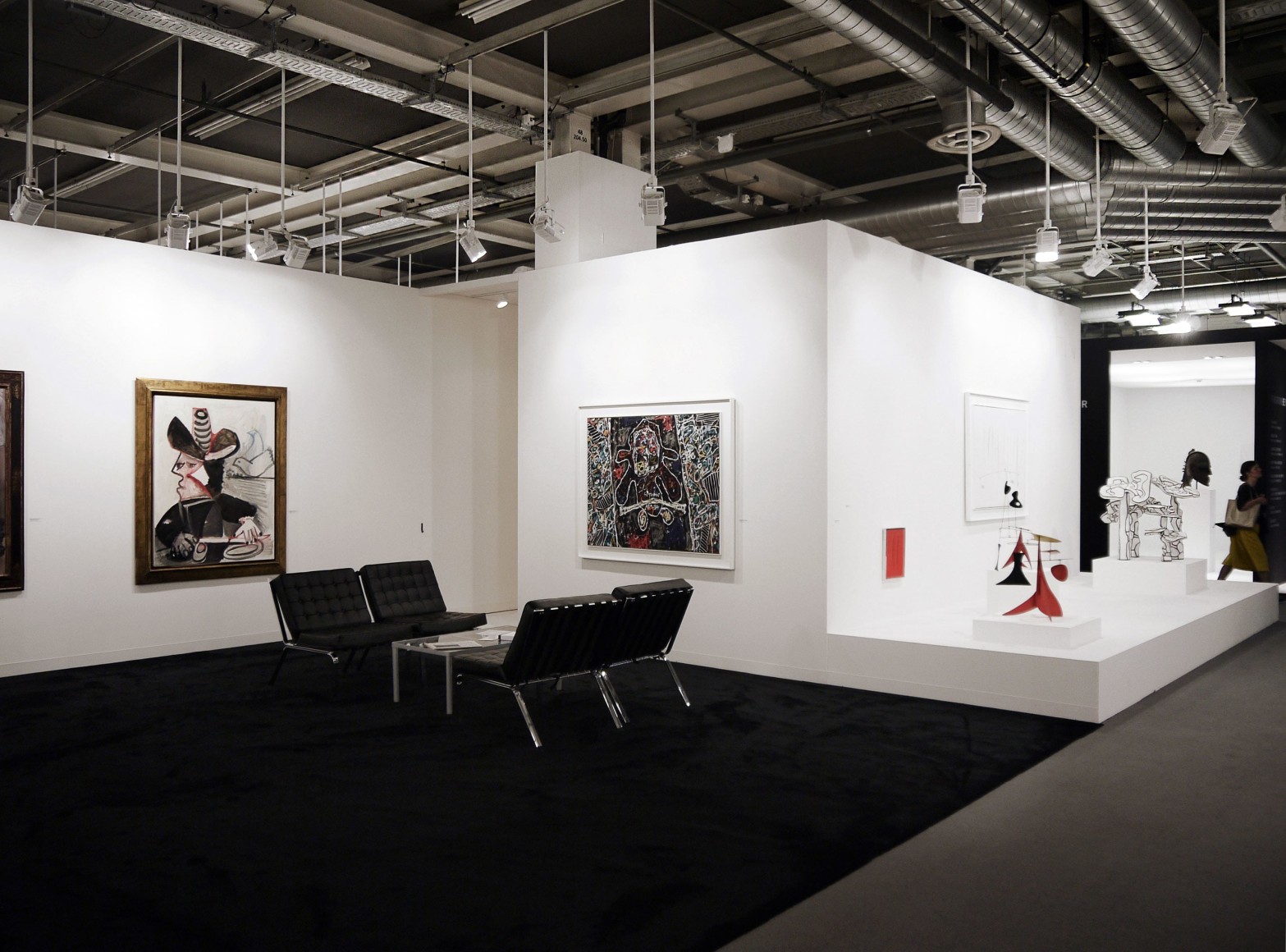 Installation view of Art Basel | Basel 2015, booth H5 featuring two paintings and four small sculptures from a distance.  &copy; 2018 Calder Foundation, New York / Artist Right Society (ARS), New York. &copy;Helly Nahmad Gallery NY