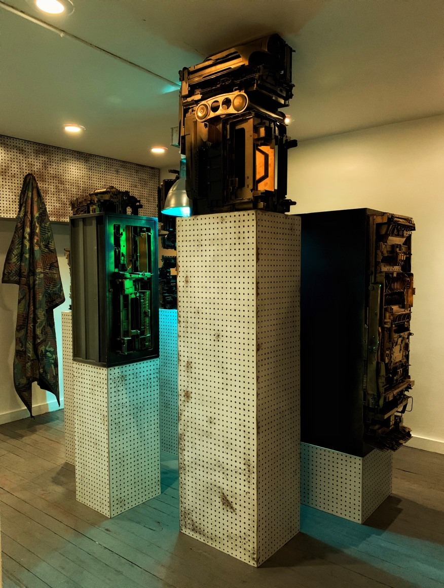 Upstairs exhibition room - Exhibiting five assemblage sculptures on pegboard pedestals- various sizes. Sculptures were placed surrounding a condensed 400-watt sulfur lamp, low hanging with a loud buzzing sound.