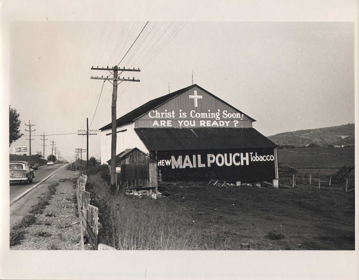 31. Simpson Kalisher, Untitled, ​n.d. A barn on the side of a country road reads &quot;Christ is coming soon! Are you ready?&quot; and &quot;New Mail Pouch Tobacco&quot;