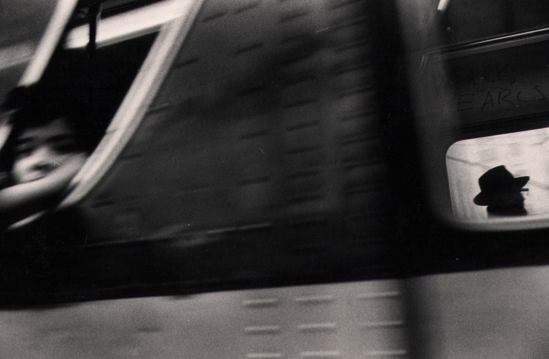 15. Anthony Barboza, NYC, 1970s. Motion-blurred close up of a subway window; two figures can be perceived on the left and right of the frame.