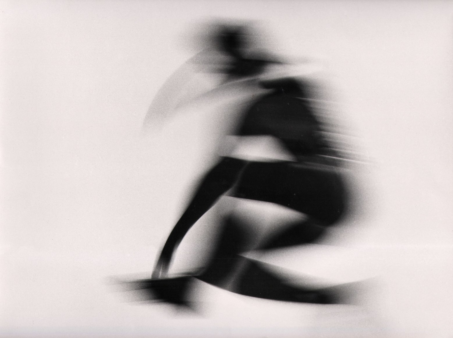 Stanislao Farri, Reggio Emilia, ​1959. Abstract silhouette of a humanoid figure blurred with motion against a white background.