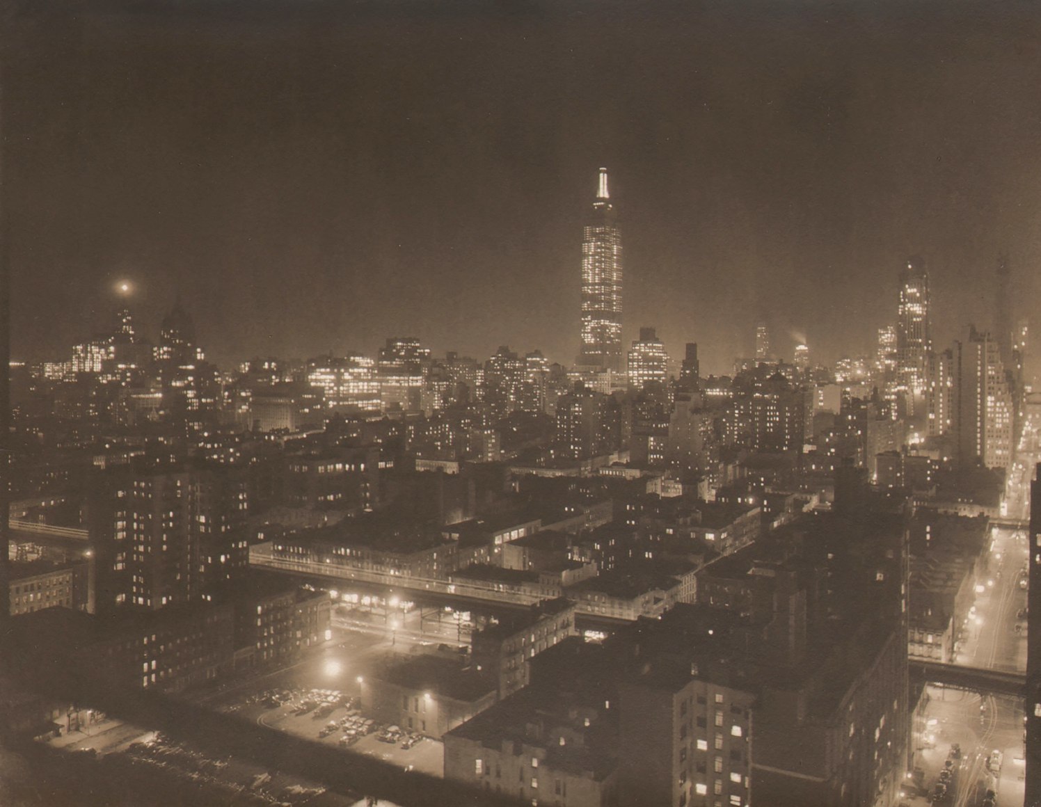 Paul J. Woolf, Empire State Building, c. 1933. Night time cityscape with Empire State Building in center of frame in background.