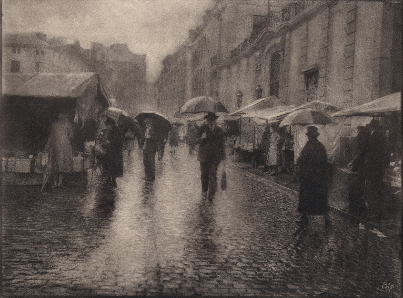 04. L&eacute;onard Misonne, Untitled, c. 1930. Figures with umbrellas walk a wet, cobbled market street. Sepia-toned print.