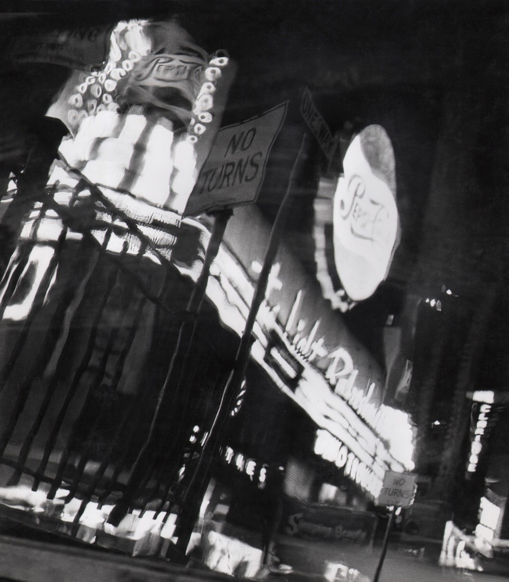 30. David Attie, Times Square, ​c. 1955. Blurry, distorted view of lit signs such as &quot;Pepsi-Cola&quot; at night.