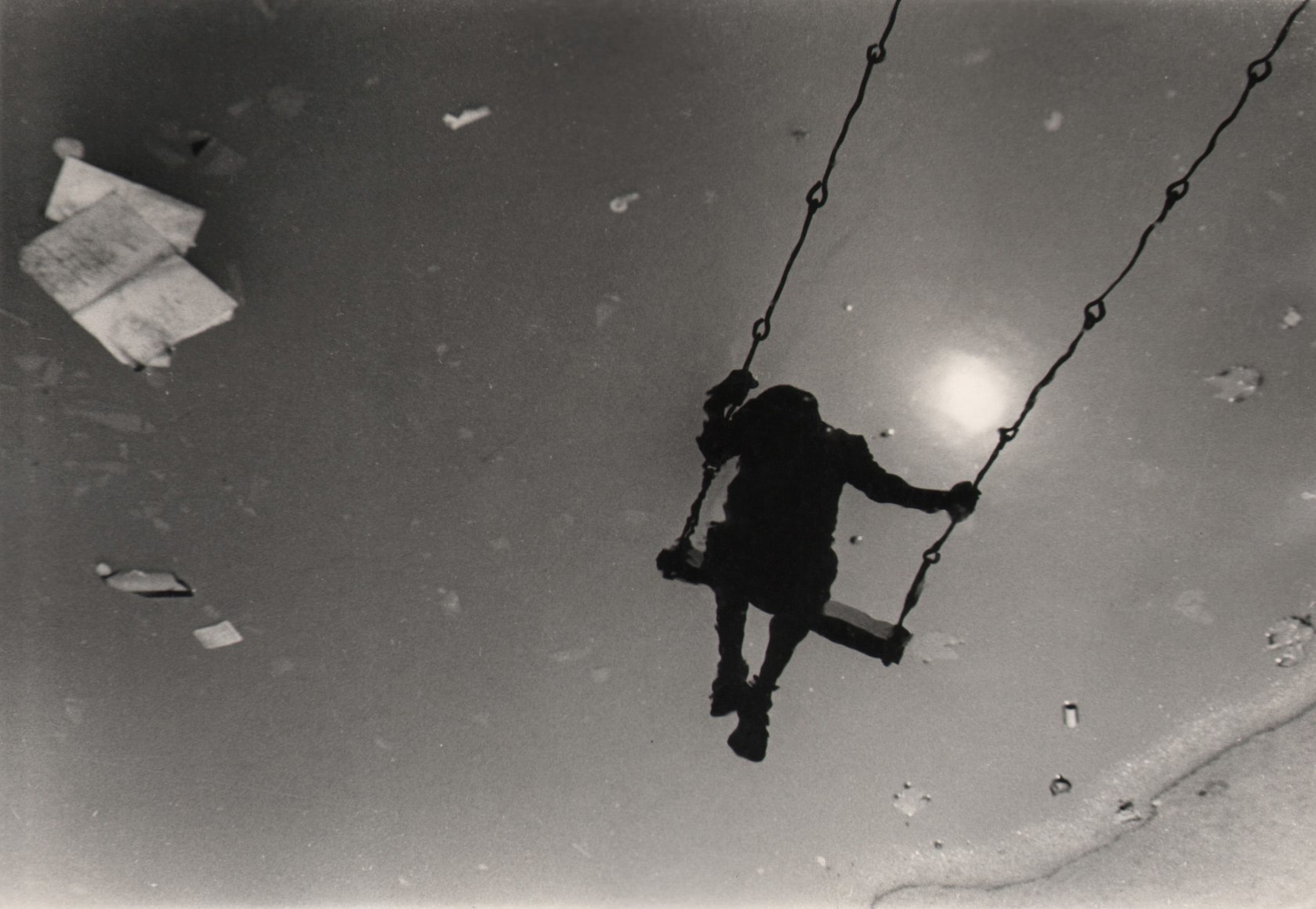 33. Beuford Smith, East 12th Street Park, NYC, (Boy on Swing), ​1968. Reflection of a silhouetted boy on a swing.