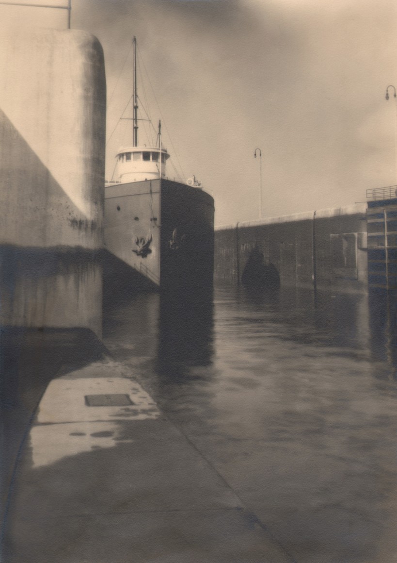 20. Margaret Bourke-White, Locks, Sault St. Marie, c. 1929. A large ship photographed from the front on a canal.