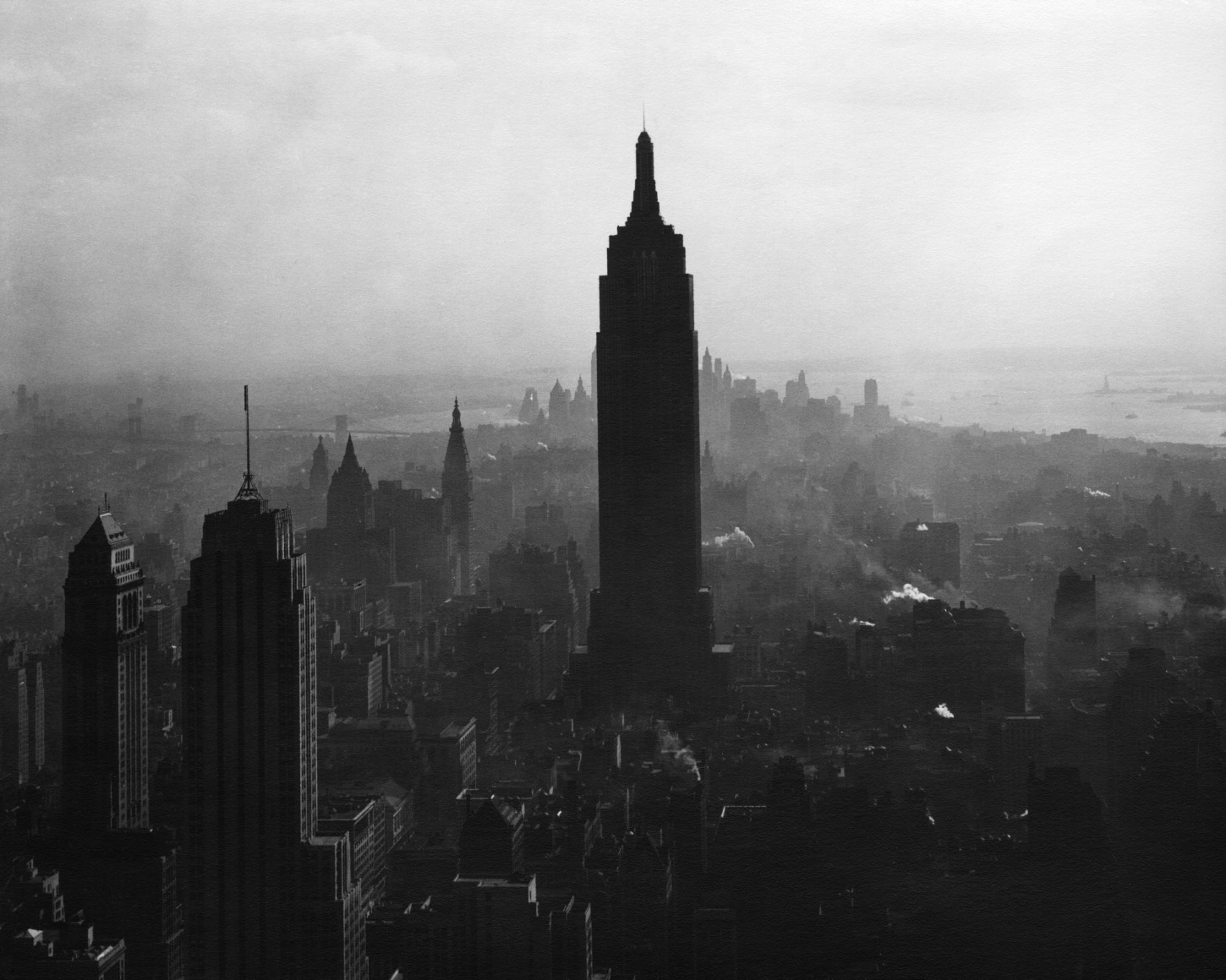53. Todd Webb, View South from the top of the RCA Building showing the Empire State Building, ​1947. Birds-eye view of a hazy skyline with the Empire State Building as the central silhouette.