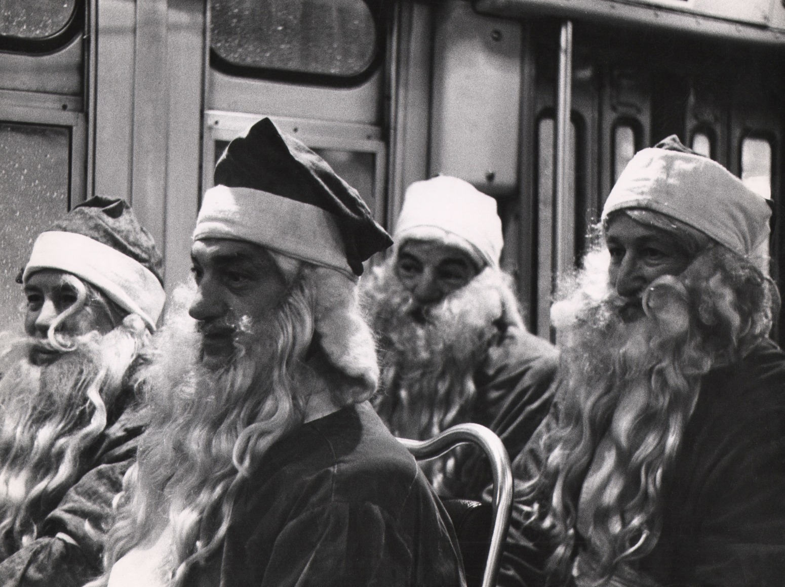 50. Bedrich Grunzweig, Four Santas in a New York Bus, Christmas, ​1954. Four seated men in Santa costumes in two rows of two.