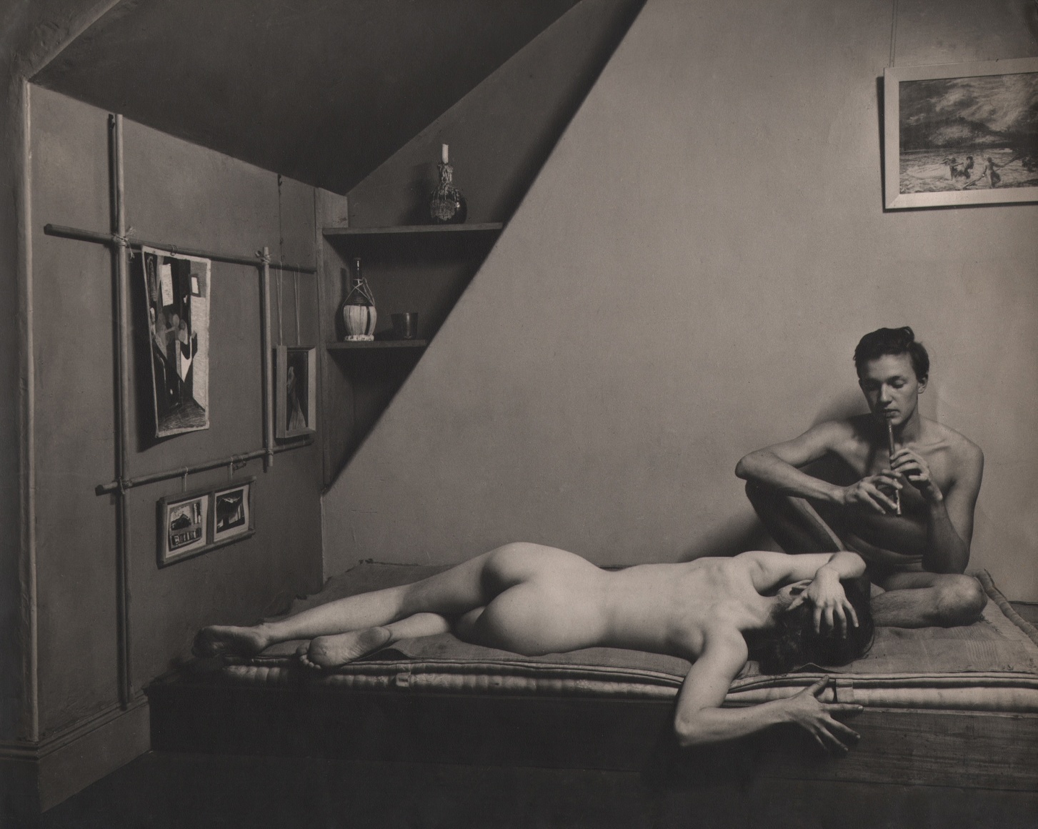 36. N.M.W. Mansill, Untitled, c. 1956. Lounging nude man and woman. The man is seated playing a small pipe, the woman laying down.