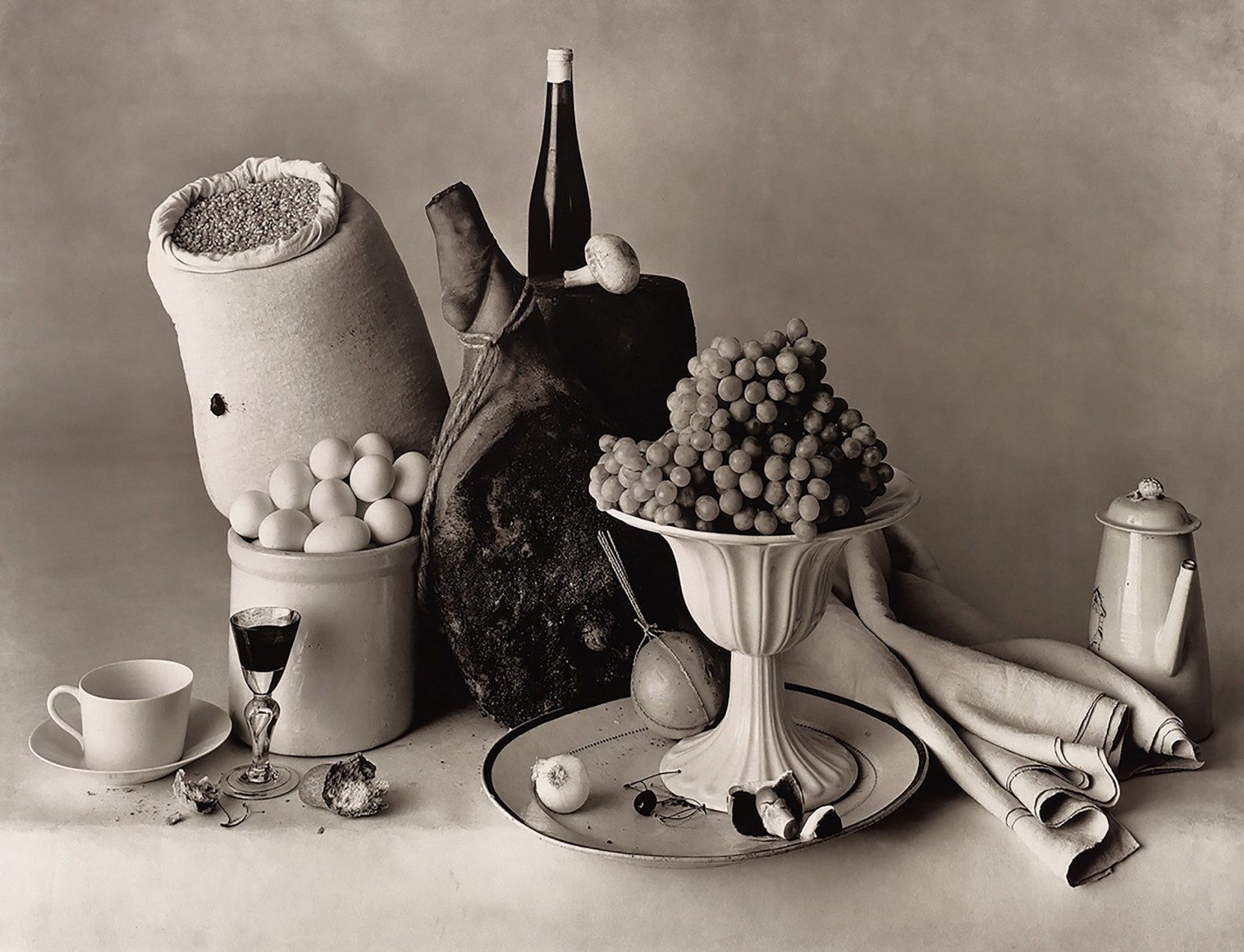 Irving Penn, New York Still Life, 1947. Studio still life featuring eggs, grapes, cloth, a mug and liquor glass, teapot, etc.