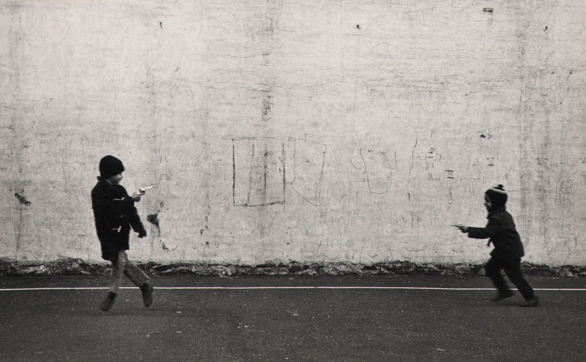 30. Beuford Smith, Lower East Side, ​1969. Two boys blurred with motion, playing with toy guns.