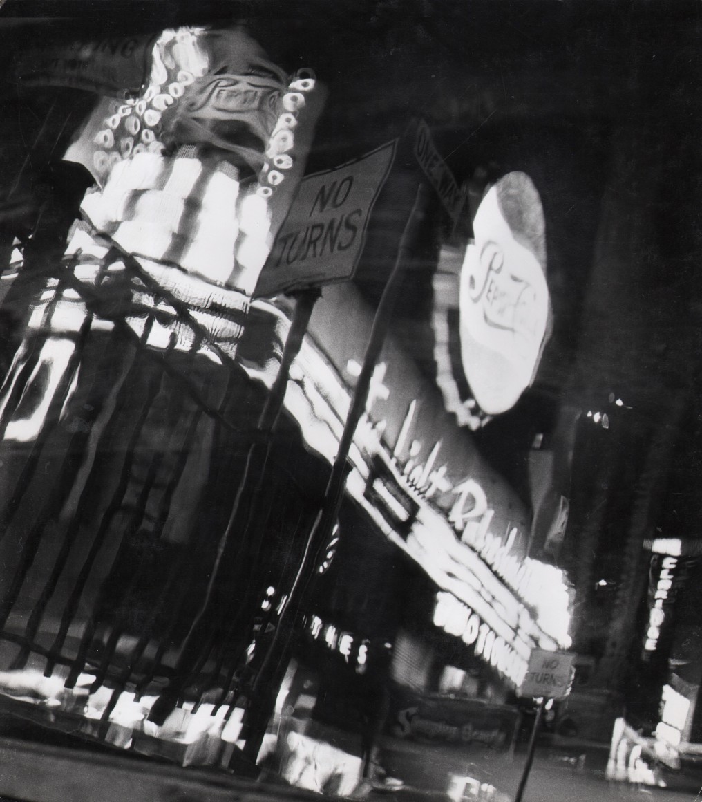 32. David Attie, Times Square, ​c. 1958. Night scene of neon signs and marquees, notably a large, round sign for Pepsi-Cola.