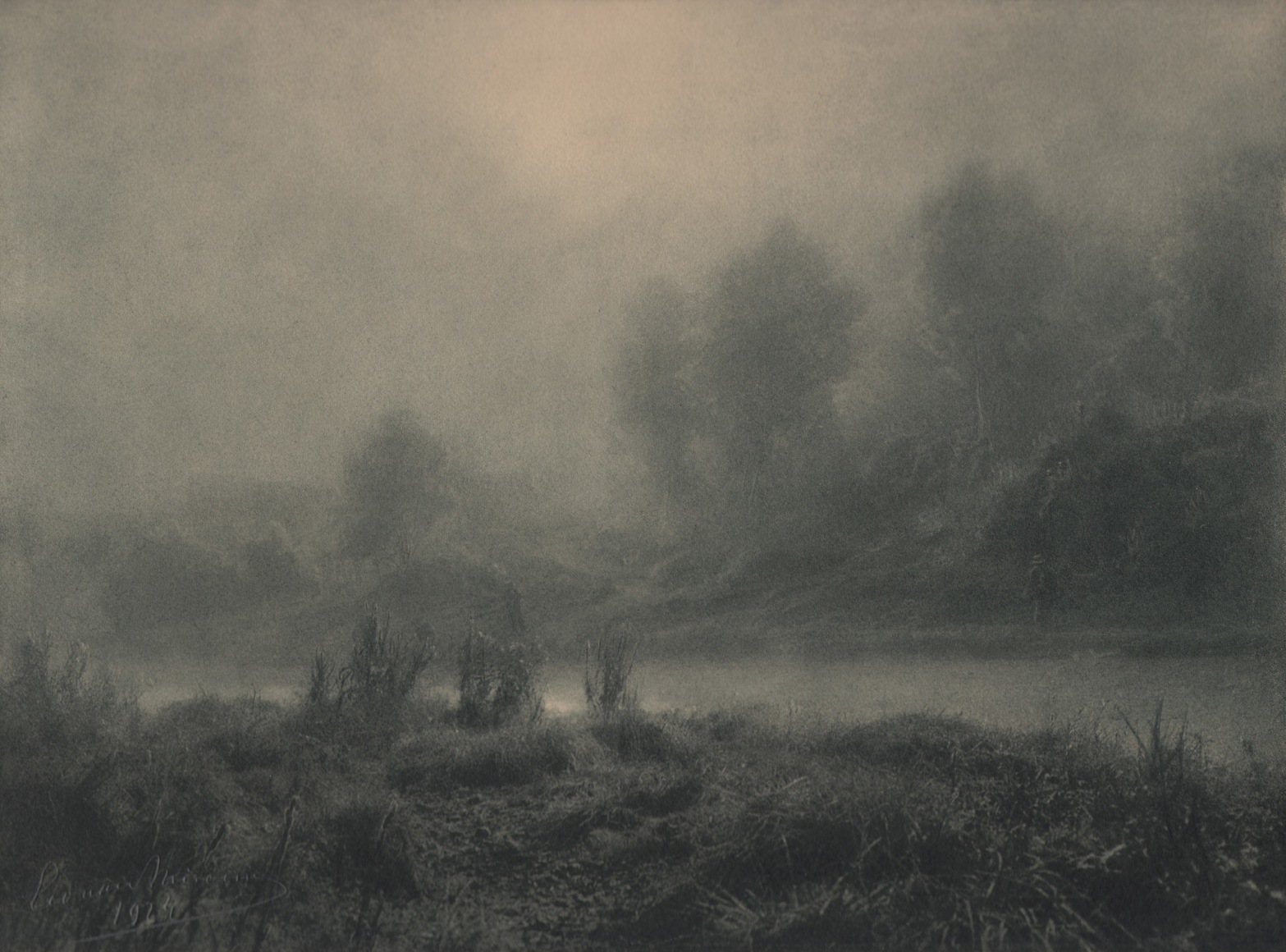 13. L&eacute;onard Misonne, Lever de soleil, c. 1924. Hazy sunrise alongside a river with brush and trees on either side. Gray/green-toned print.
