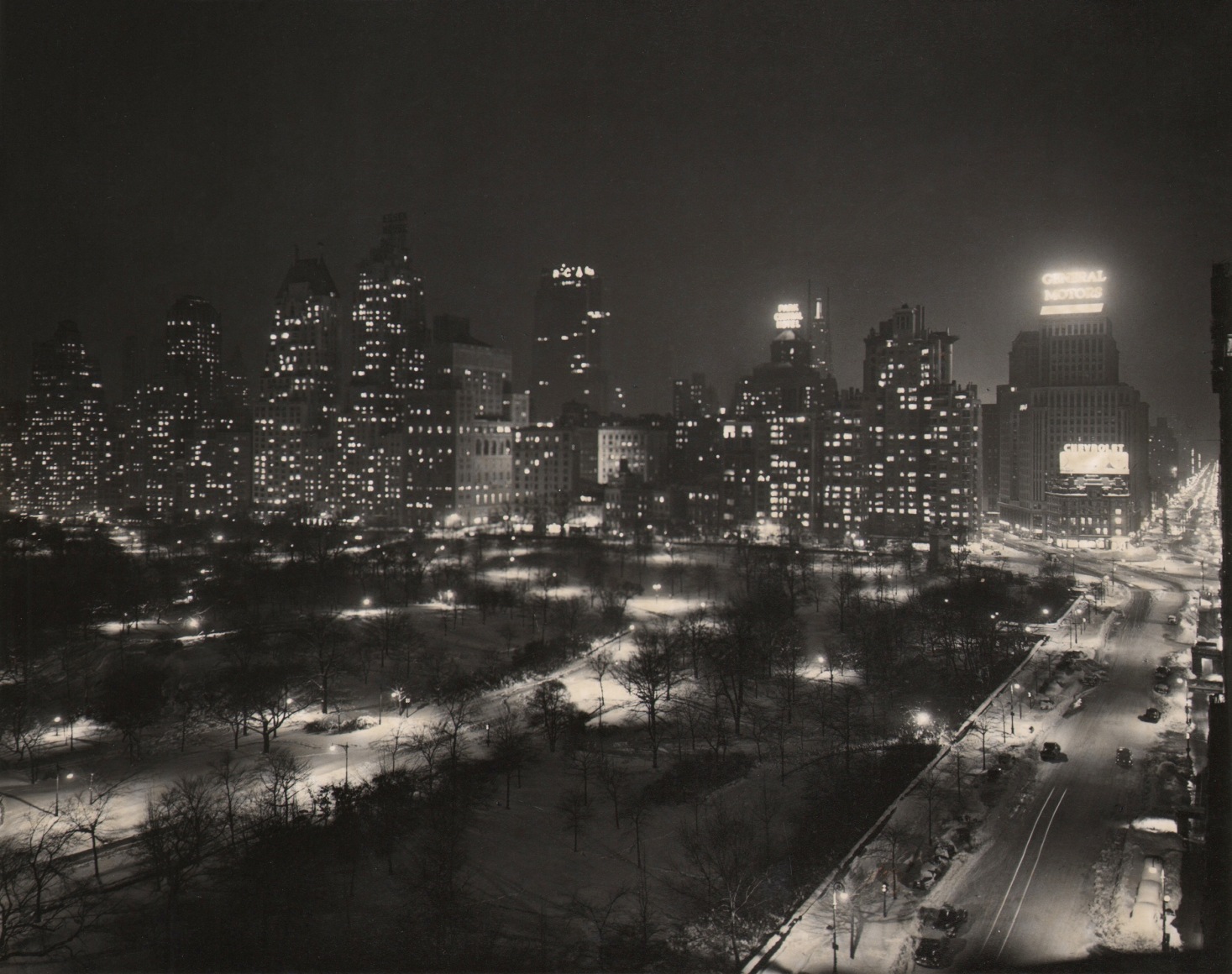 Paul J. Woolf, Central Park South &amp; West, ​c. 1935. Night time cityscape with park on lower left, street running up the right of the frame, and buildings across the middle of the frame.