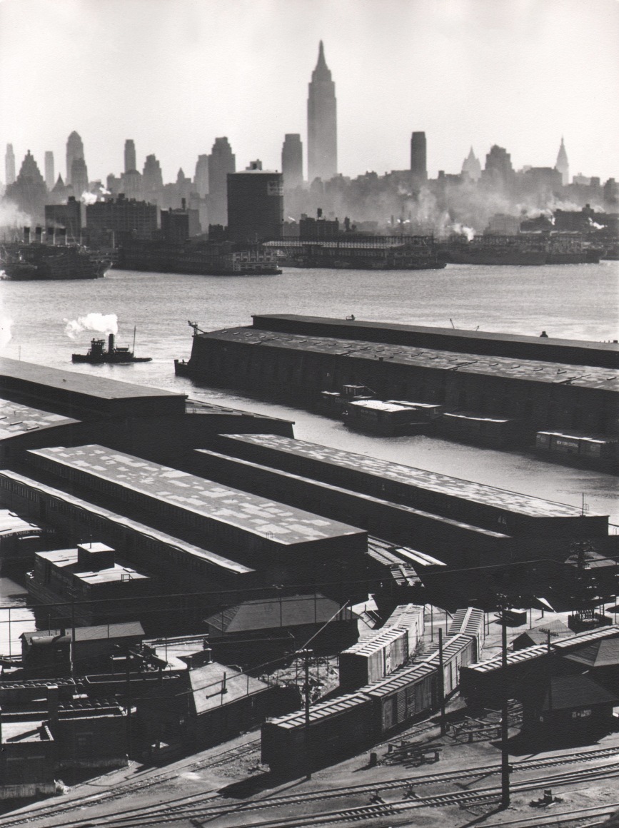 48. Esther Bubley, Weehawken, New Jersey. View looking east from 50th Street and East Boulevard showing New York Central piers, Hudson River and Midtown Manhattan skyline, 1946.