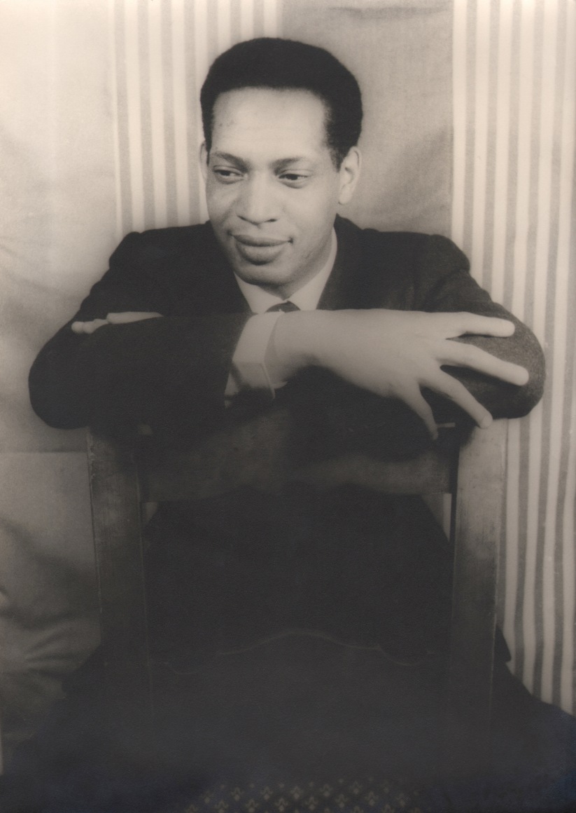 22. Carl Van Vechten, William Demby, 1956. Seated portrait of subject seated backwards with arms folded on the back of a wooden chair.