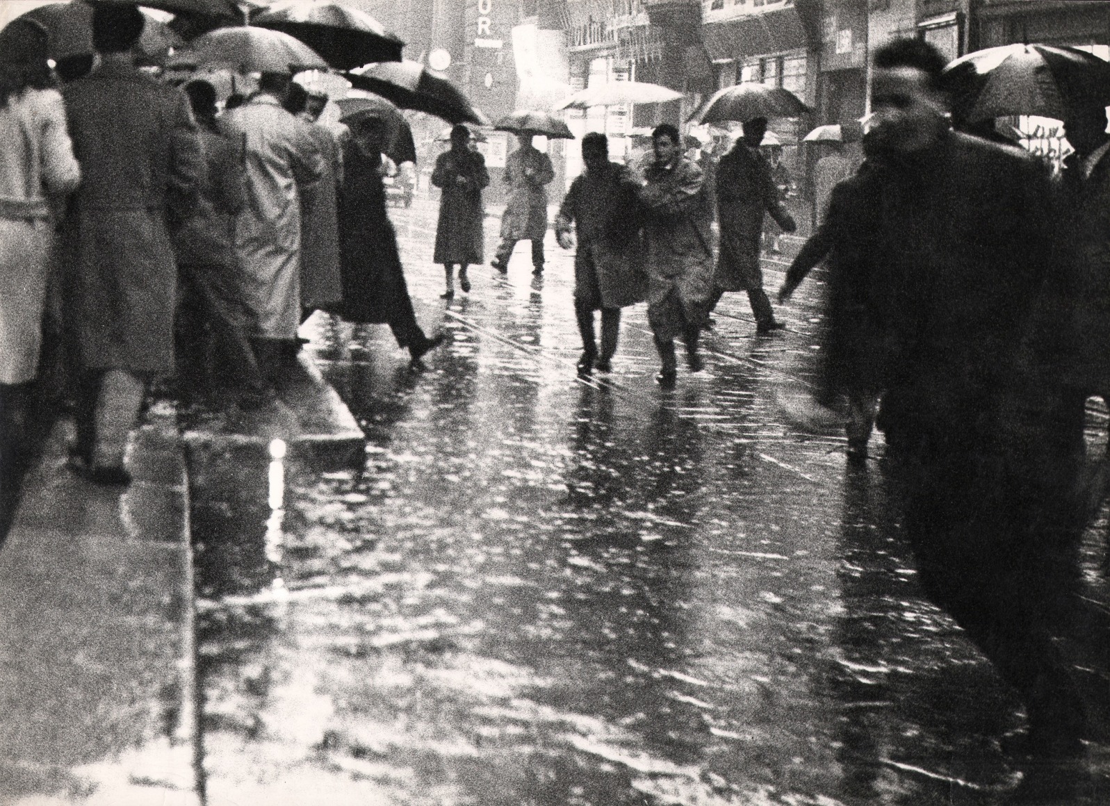 Cesare Colombo, Milano, ​1958. Street scene with many figures hurrying through the rain with umbrellas.