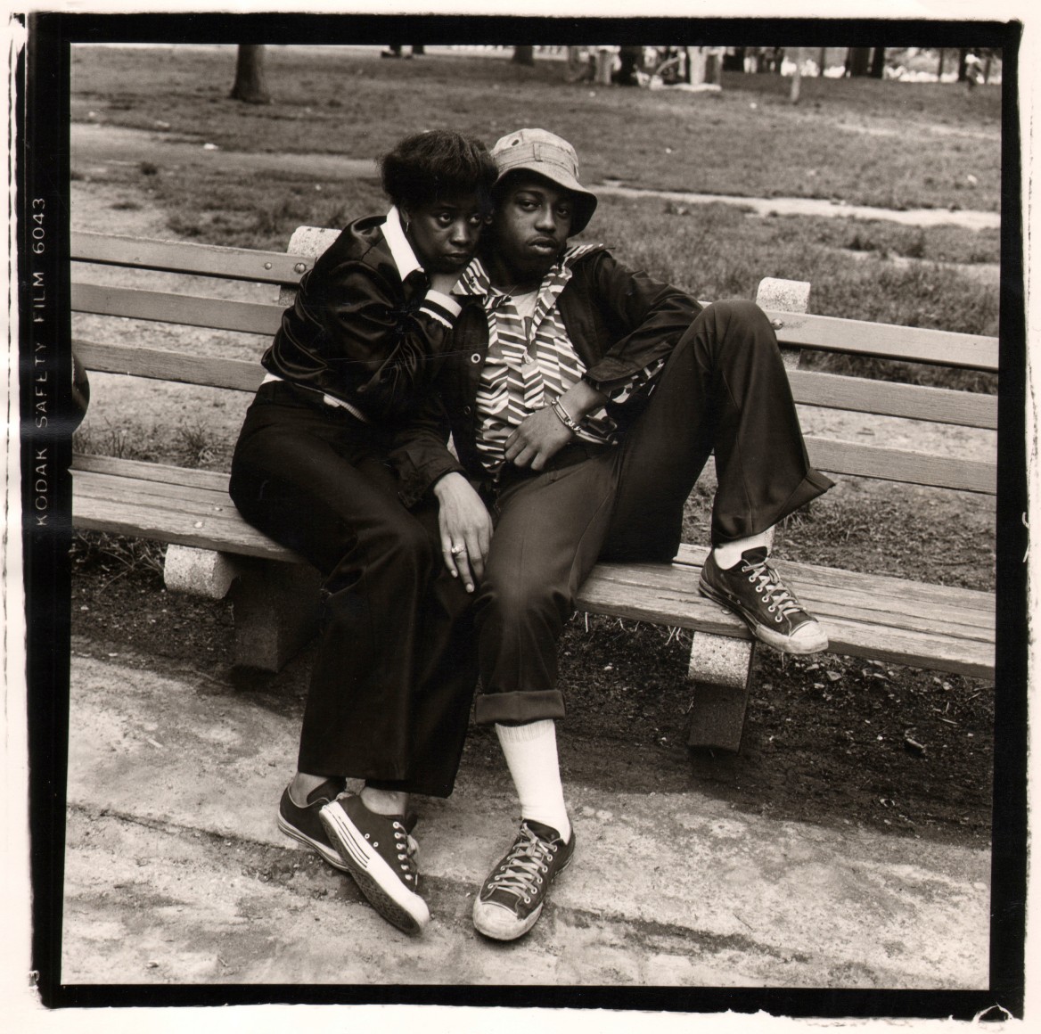 20. Anthony Barboza, NYC, ​1970s. A black couple recline on a wooden park bench.