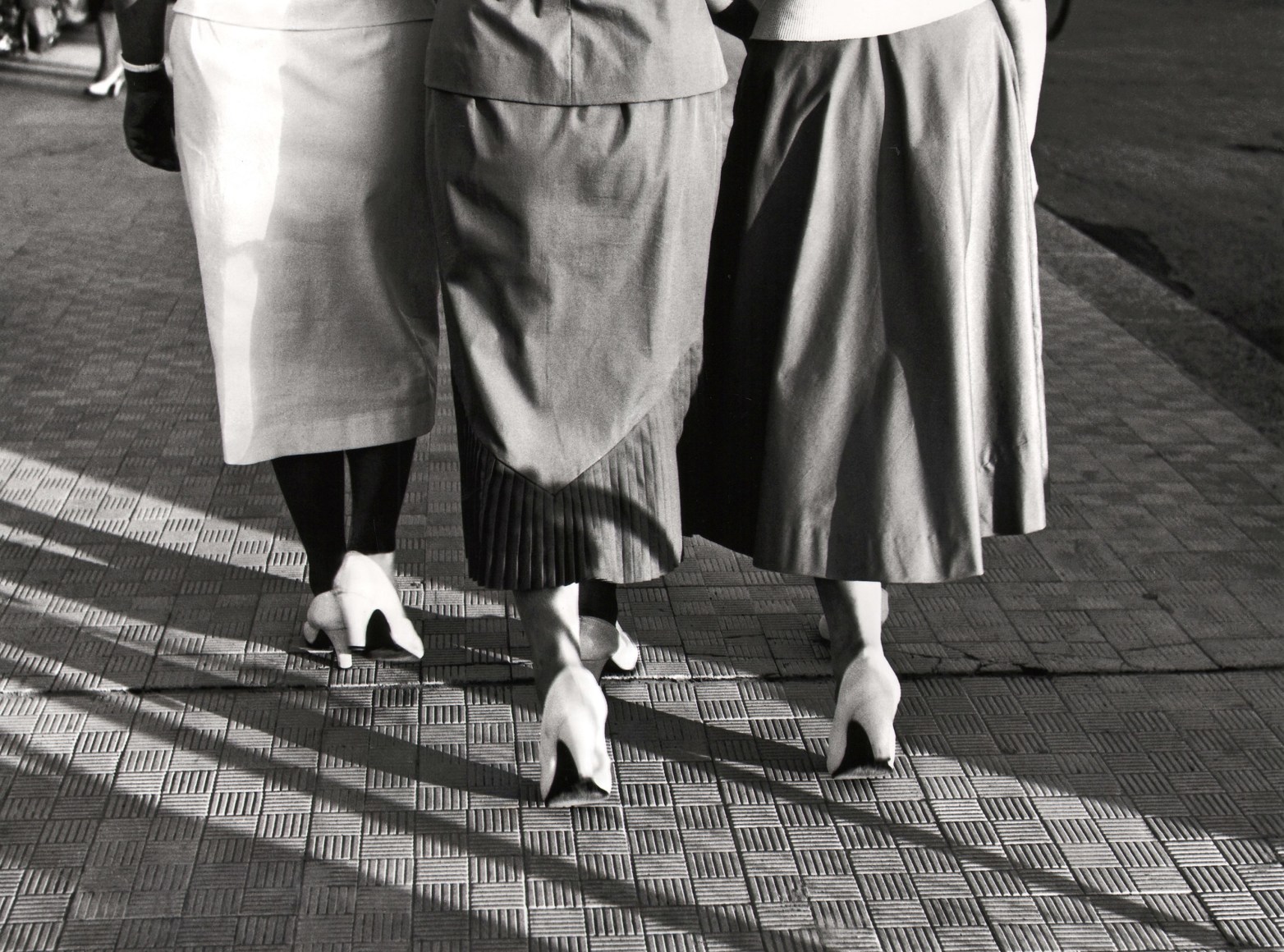 Nino Migliori, White Shoes, 1951. Three women photographed from behind from the waist down in matching white heels.