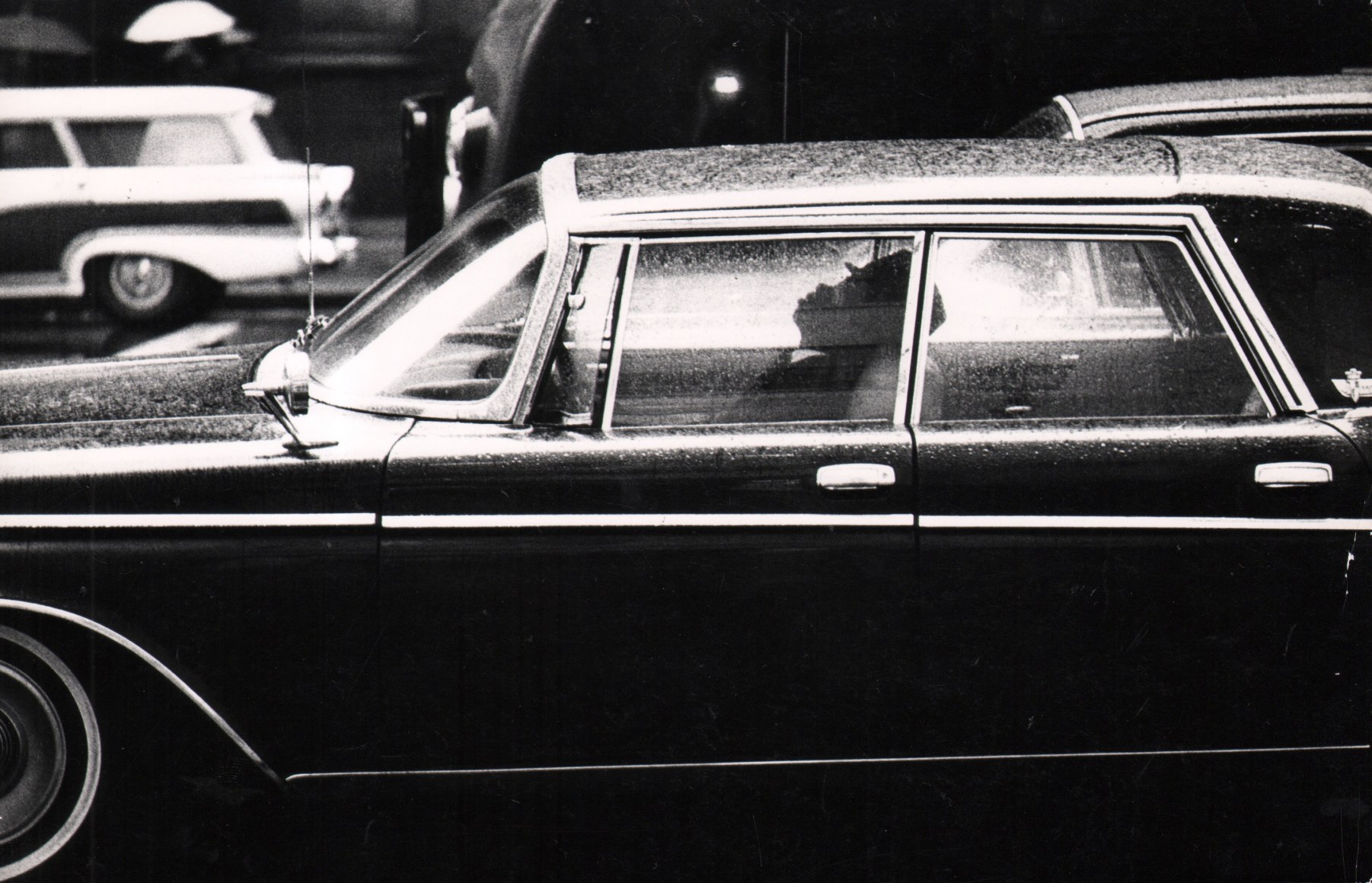 2B. Jan Lukas, New York, 1964. Side view of a man sleeping in the front seat of a parked car.