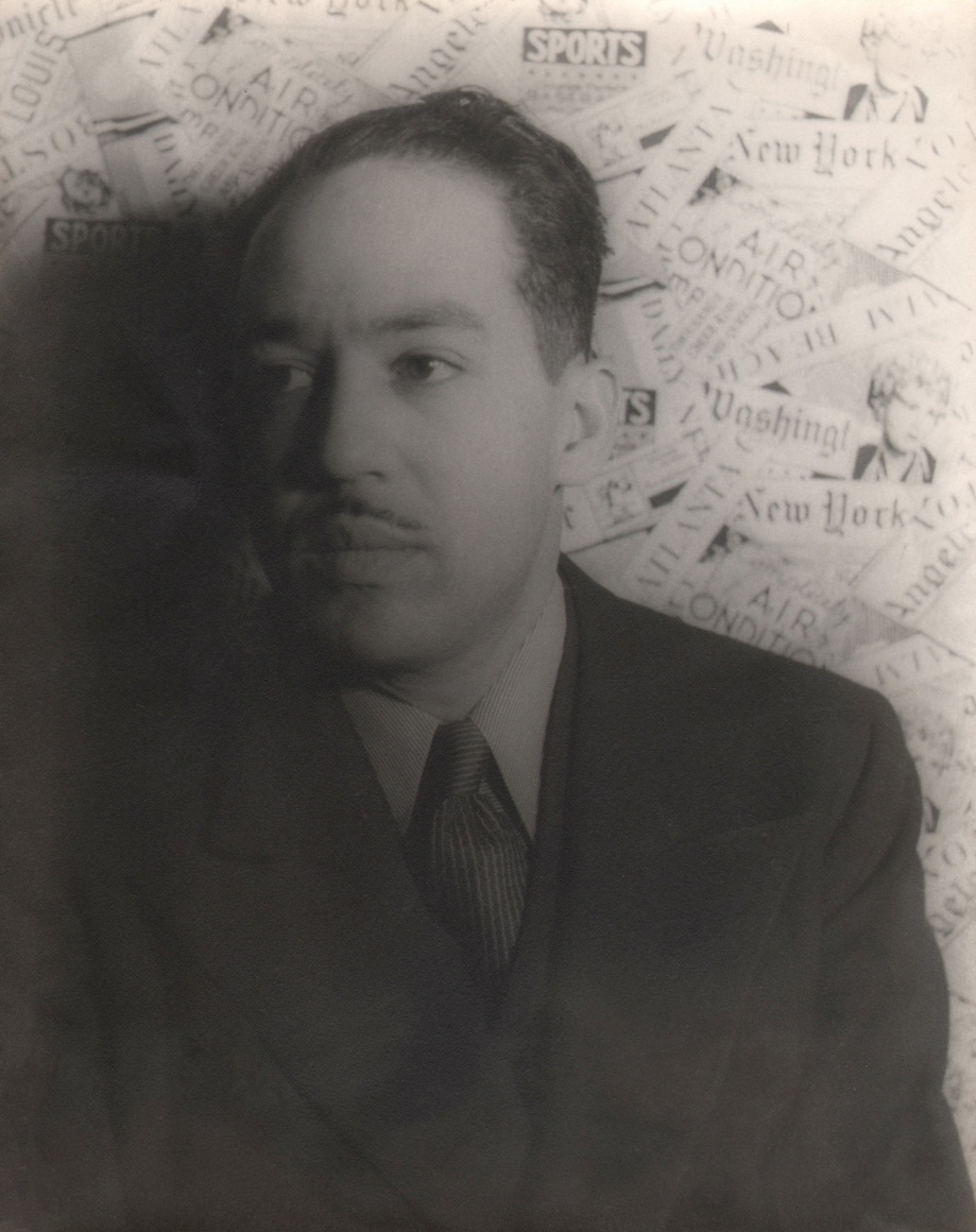 27. Carl Van Vechten, Langston Hughes, 1936. Bust-length portrait with subject in suit and tie against a collaged newspaper backdrop, looking slightly to the left of the frame.