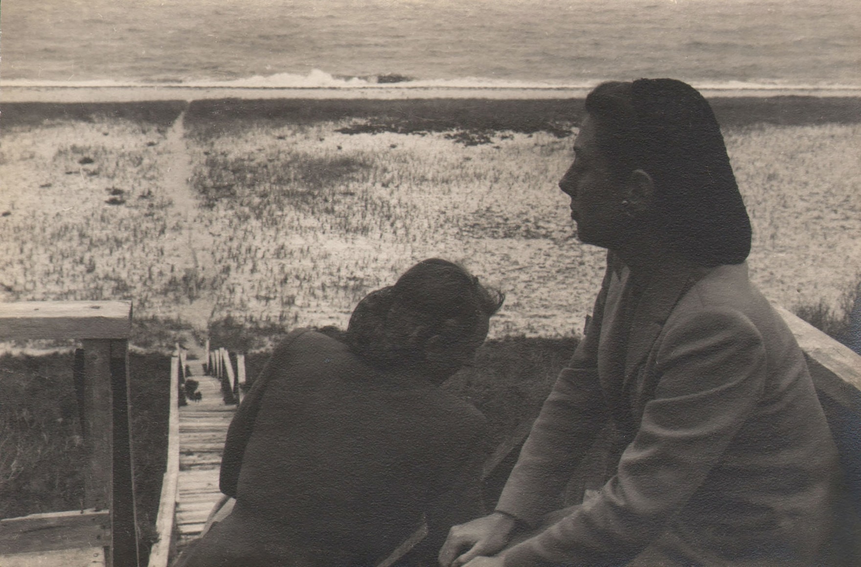 PaJaMa, Fidelma Cadmus and Margaret French, Nantucket, ​c. 1945. Two women seated at the top of a tall flight of wooden stairs that lead down to a beach. One faces left, the other has her back to the camera.