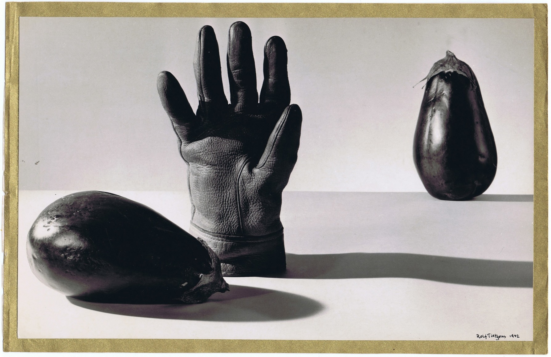 Rolf Tietgens, Artificial Landscapes, ​1942. An upright leather glove between two eggplants, one on its side and one upright.