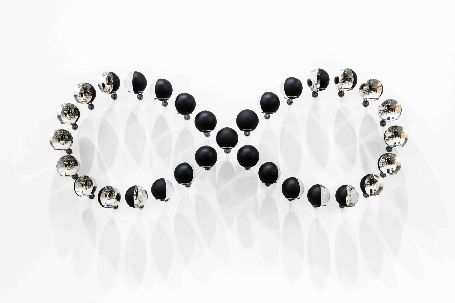 Olafur Eliasson, Infinite conversation (lunar infinity), 2017. 31 glass spheres, silver, stainless steel, paint (black),, 73 x 188.5 x 20.5 cm (each sphere: 12 cm). Courtesy of the artist & PKM Gallery.