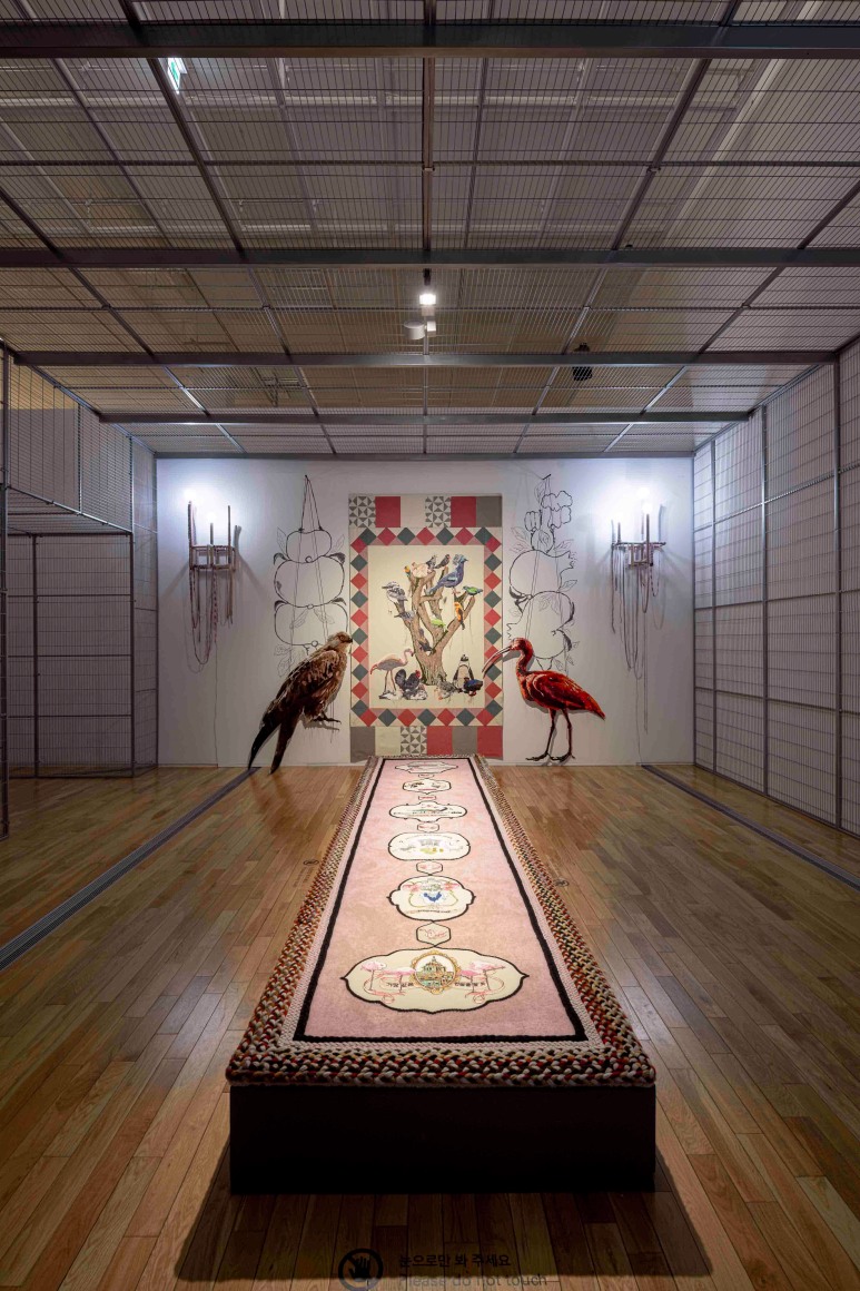 Young In Hong, To Paint the Portrait of a Bird, 2019. Metal cage, video projection, wood, recycled yarn, fabric, embroidery on cotton, light bulbs, metal, sound installation. Courtesy of the artist & PKM Gallery., Photo Credit: Korea Artist Prize Exhibition 2019, MMCA, Seoul.