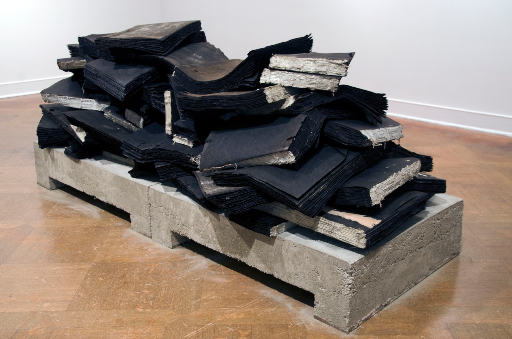 TRAVIS J. WAGNER Ta Biblia 2014, tar paper, twine, adhesive, concrete and steel, 33 x 88 x 40 inches.