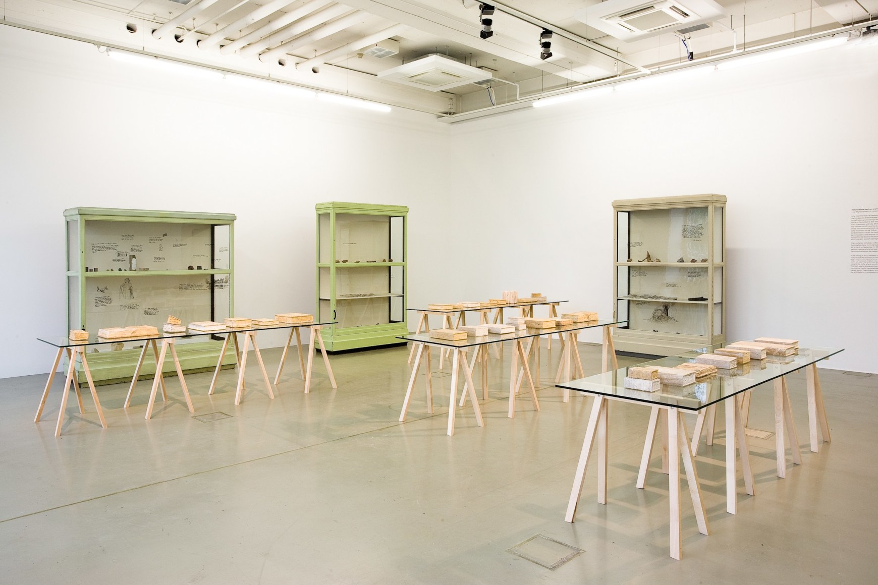 Michael Rakowitz, What dust will rise?, 2012, Bamiyan travertine, glass, vitrines, bullets, shrapnel, meteorites, Libyan desert glass, trinitite, fragments of the destroyed Buddhas of Bamiyan, books burned during the Second World War