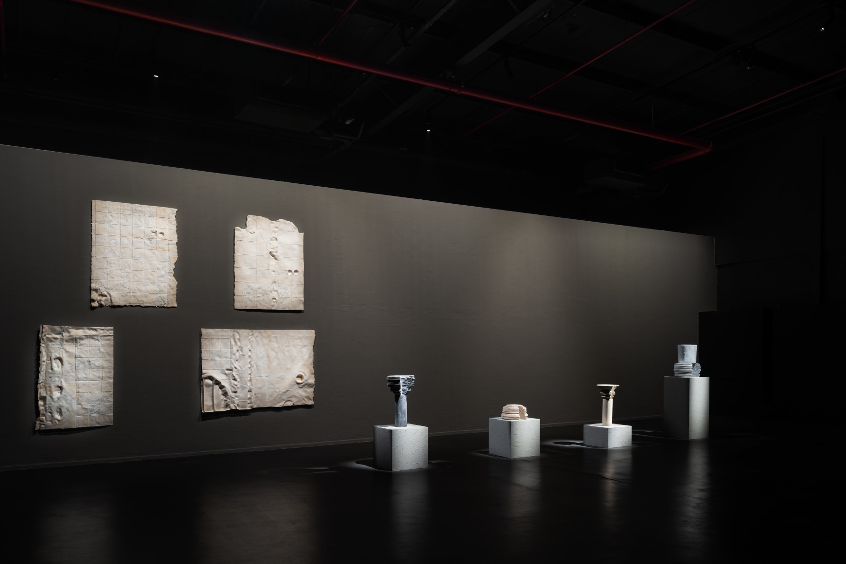 After Rain, Diriyah Contemporary Art Biennale 2024, Nazgol Ansarinia Four works from the series Membrane (parts) (2014), Paper, paste, and glue, Four works from the series Pillars (2014&ndash;18), Cast resin, paint, Courtesy of the Diriyah Biennale Foundation, photo by Marco Cappelletti