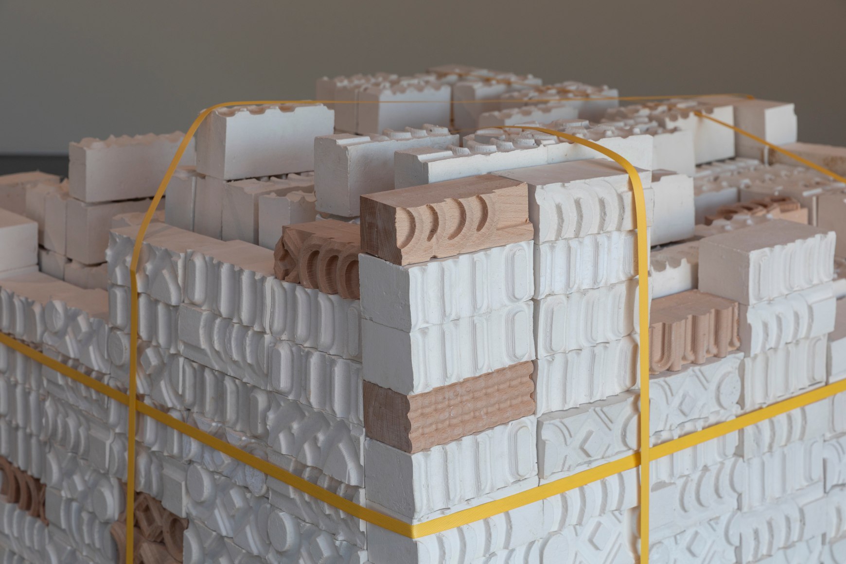 Asma Belhamar, Mother Mould, 2023, Plaster and wood, 400 pieces, each piece is approximately 18 x 18 x 6 cm