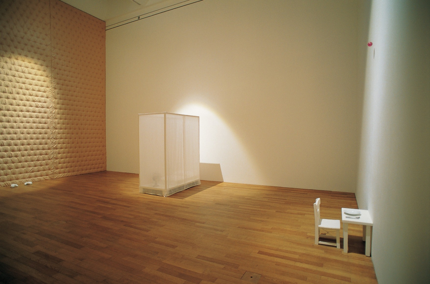 Hale Tenger, Heartache, 1999, Cloth, cibachrome print, cheld&#039;s boxing gloves, chair and table, plate, spoon, scalpel blade, pink ball, child&#039;s bed and pillow, fan and audio, Dimensions variable