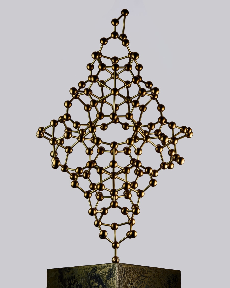 Fine mineral photograph of a brass Tourmaline molecular model for wilensky exquisite minerals habits exhibition.