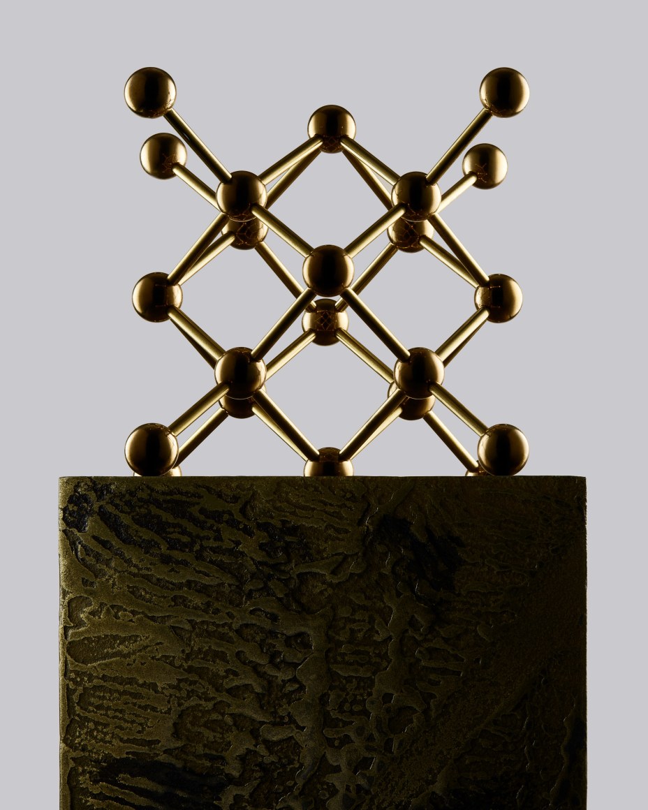 Fine Mineral photograph of a brass fluorite molecular model for wilensky exquisite minerals habits exhibition.