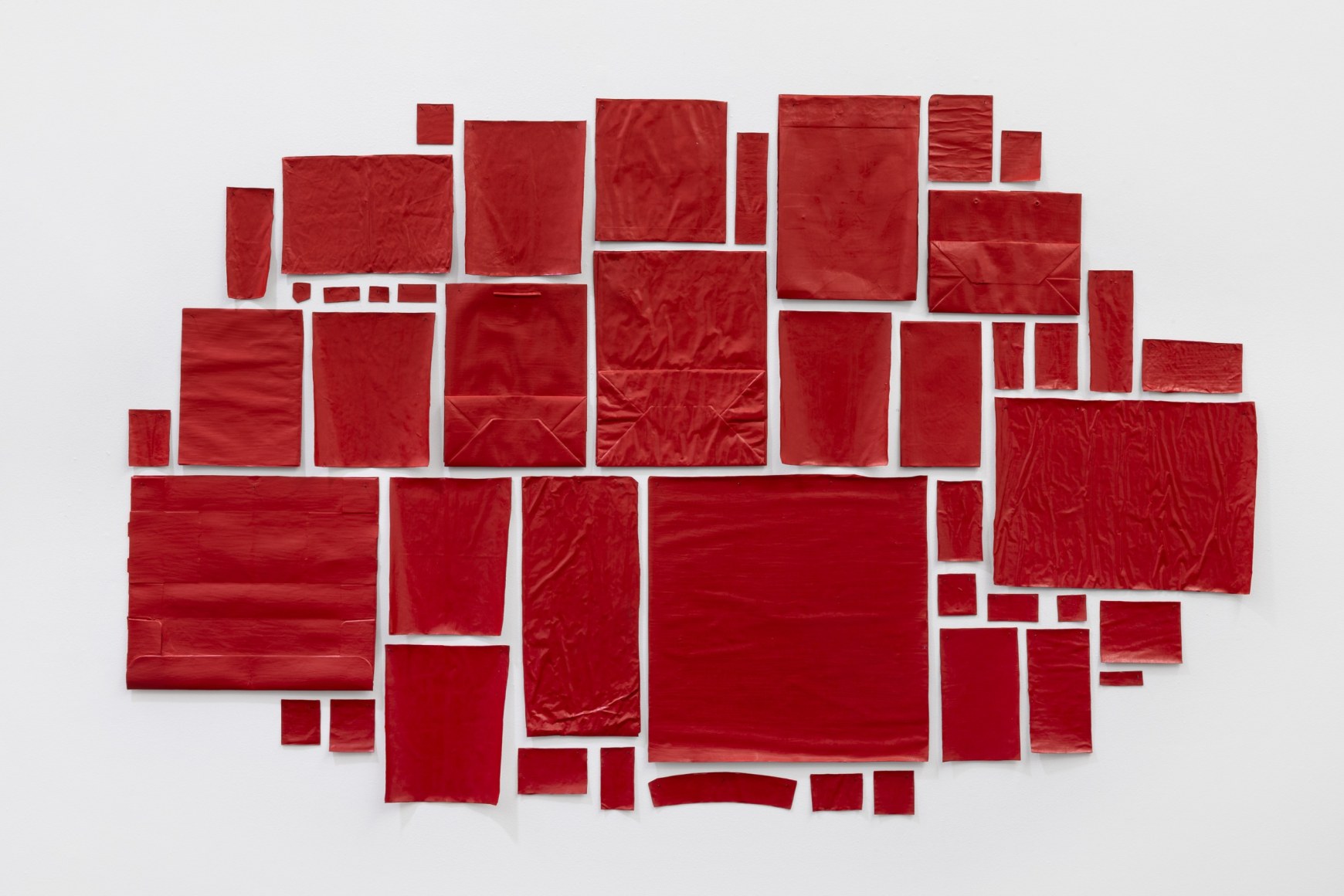 abraham cruzvillegas, 2025. red acrylic paint on newspaper clippings, cardboard, photographs, drawings, postcards, envelopes, tickets.