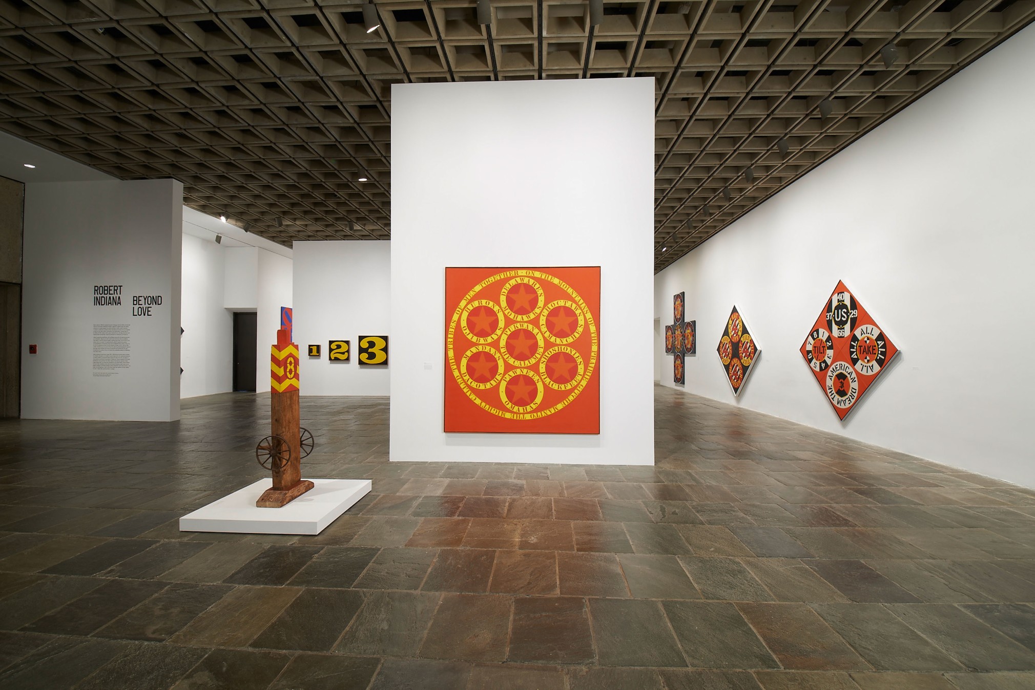 Installation view of&nbsp;Robert Indiana: Beyond LOVE, Whitney Museum of American Art, New York, September 26, 2013&ndash;January 5, 2014 featuring one wooden sculpture and five paintings.