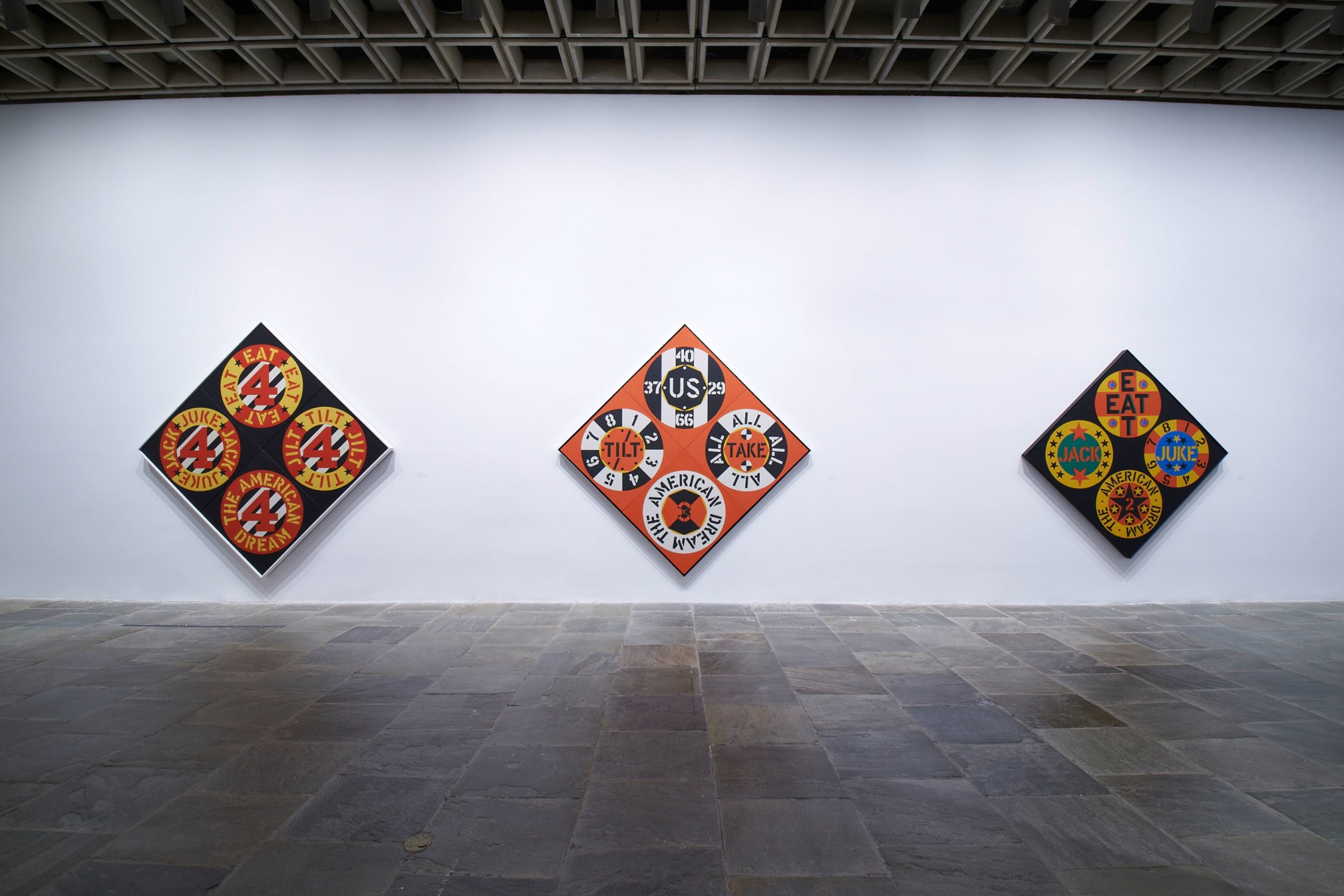 Installation view of Robert Indiana: Beyond LOVE, Whitney Museum of American Art, New York, September 26, 2013&ndash;January 5, 2014. Left to right, The Beware-Danger American Dream #4 (1963), The Red Diamond American Dream #3 (1962), and The Black Diamond American Dream #2 (1962), &nbsp;