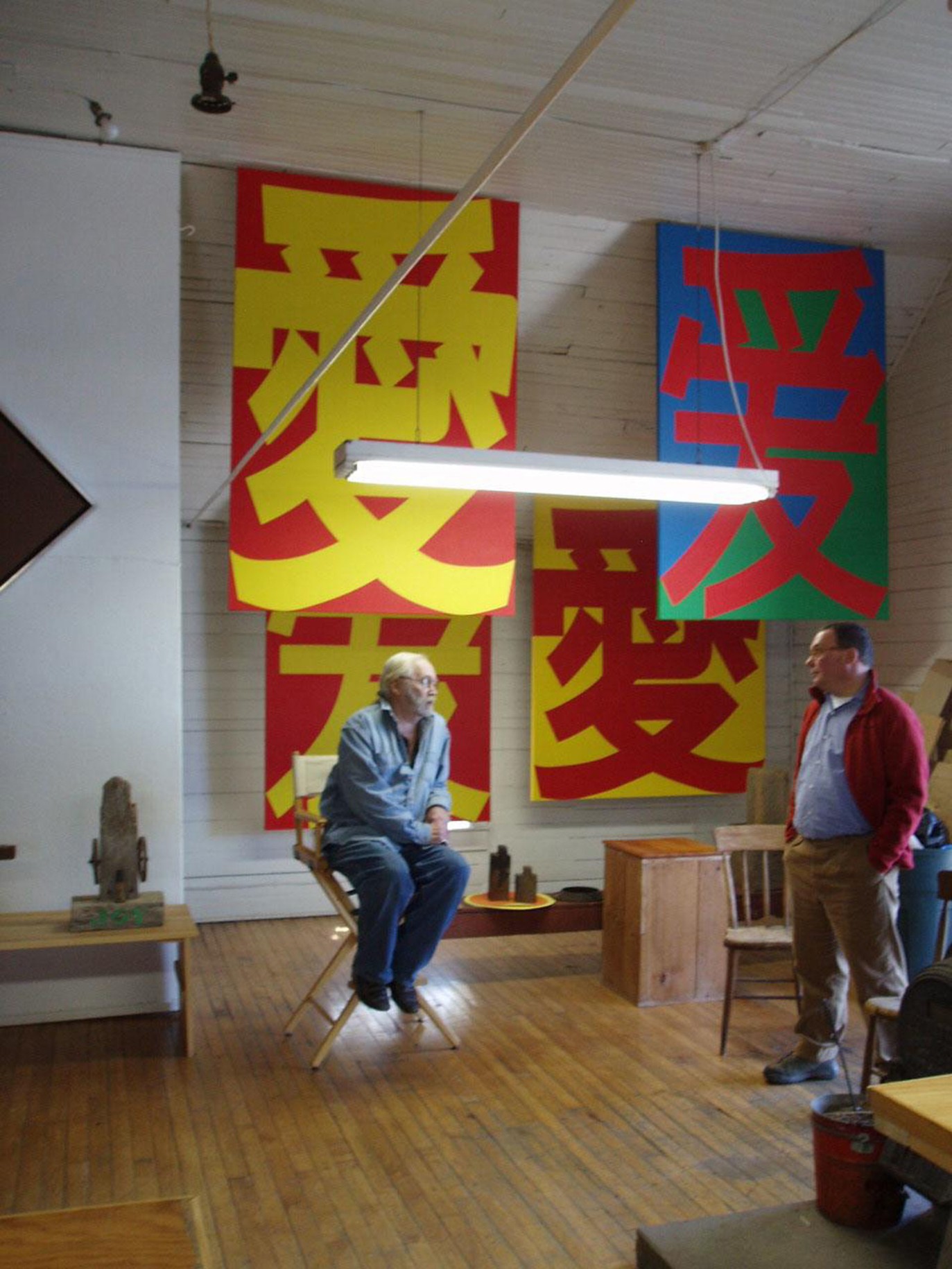 Indiana and Paul Kasmin in the artist&rsquo;s studio in 2005 with canvases from his &Agrave;i series