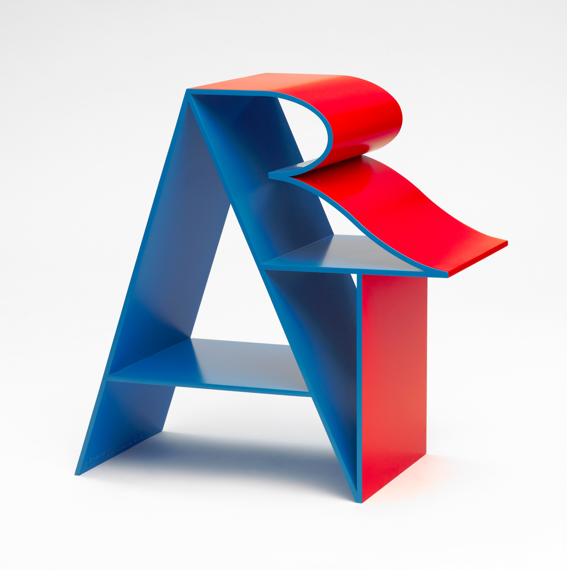 ART is an 18 by 18 by 9 inch blue and red polychrome aluminum sculpture. The letter &quot;A&rdquo; forms a supporting structure that the &ldquo;R&rdquo; and &ldquo;T&rdquo; lean against.