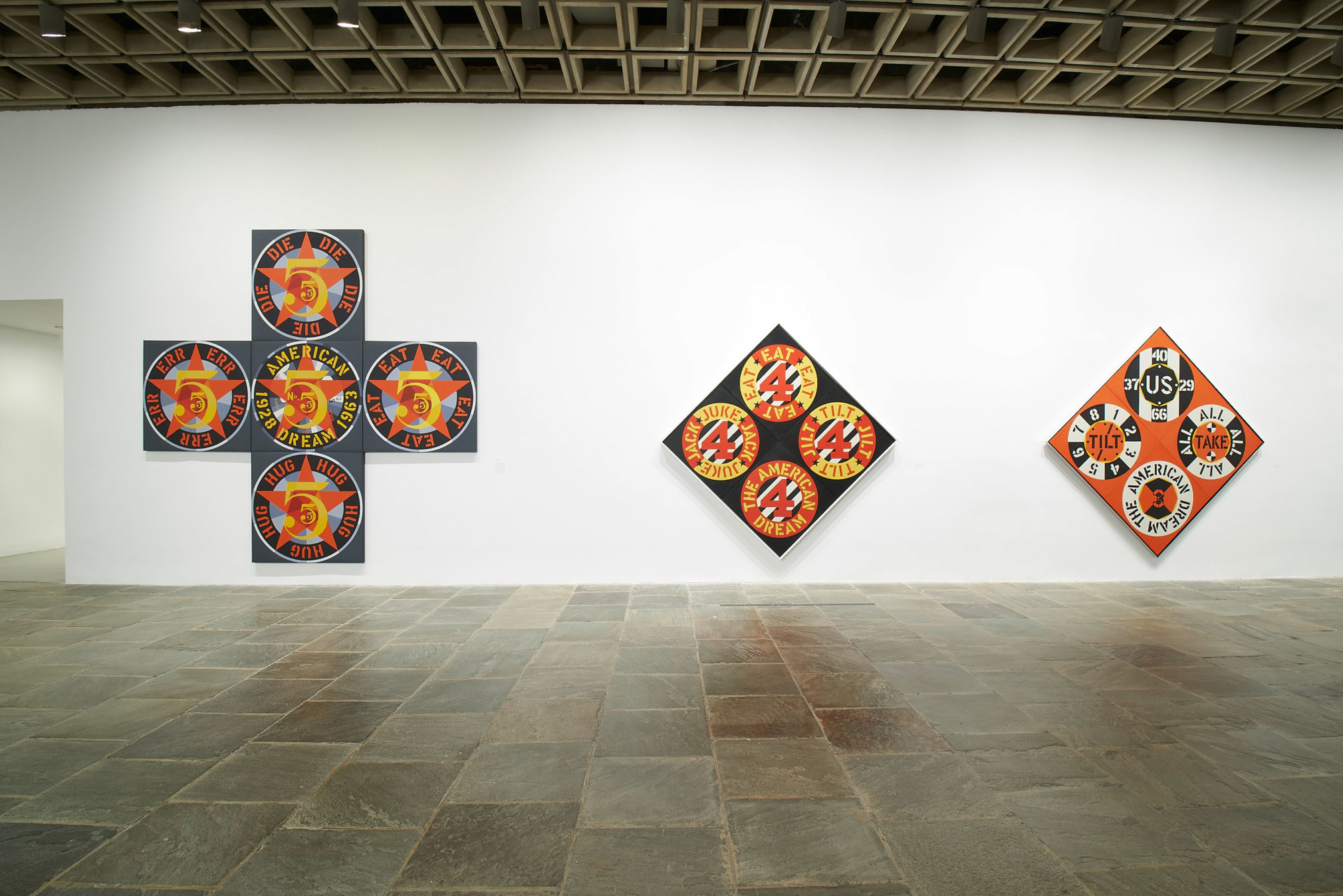 Installation view of Robert Indiana: Beyond LOVE, Whitney Museum of American Art, New York, September 26, 2013&ndash;January 5, 2014. Left to right, The Demuth American Dream No. 5 (1963), The Beware-Danger American Dream #4 (1963), and The Red Diamond American Dream #3 (1962), &nbsp;