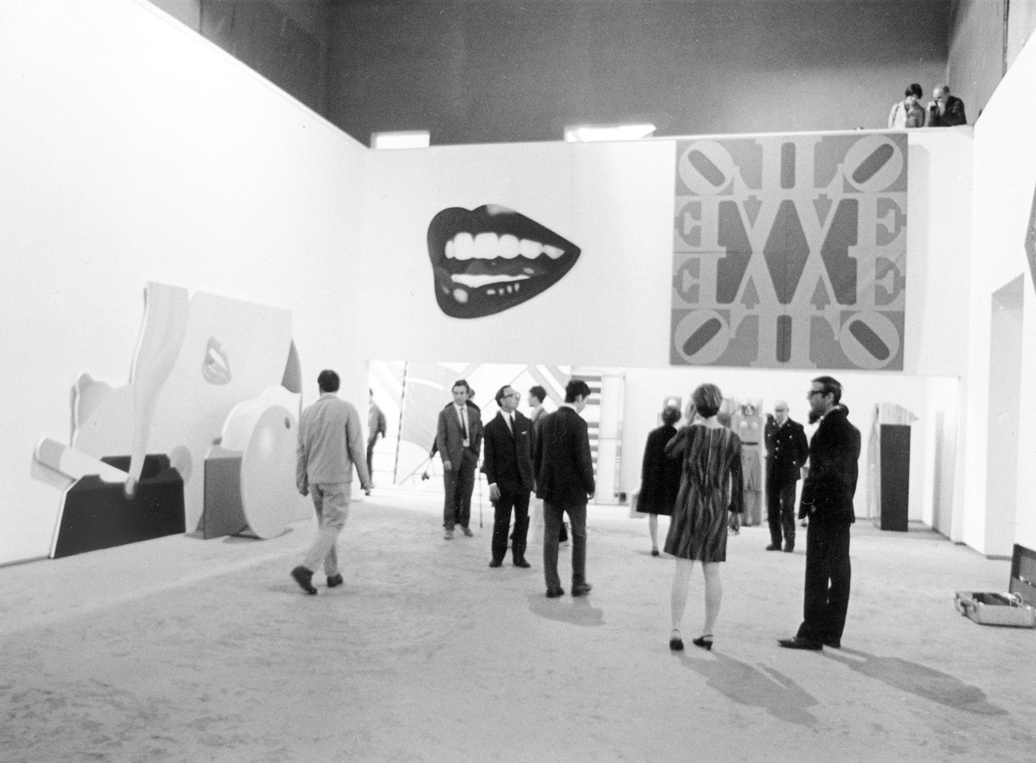 Installation view, Documenta 4, Kassel, Germany, June 27&ndash;October 6, 1968. Left to right, Tom Wesselman&rsquo;s Great American Nude No. 98 (1967) and Mouth No. 15 (1968) and Indiana&rsquo;s LOVE Wall (1966), with the panels hung incorrectly